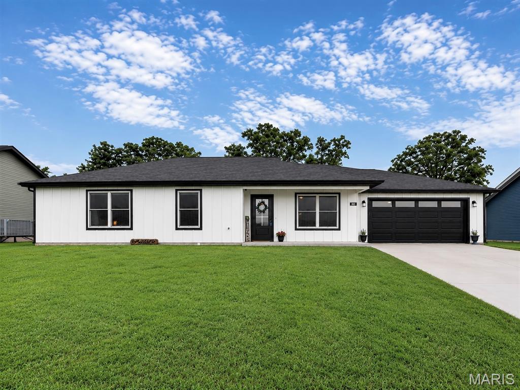 Why wait to build when you can move right into this stunning, like-new ranch home built in 2022. Situated on a premium lot backing to mature trees for added privacy, this beautifully designed 3-bedroom, 2-bath home offers the perfect blend of modern style, comfort, and convenience. One of its standout features is the unusually large, level backyard—a rare find in newer construction—providing plenty of space for pets, play, gardening, entertaining, or even a future pool. The open-concept floor plan is ideal for everyday living and entertaining, featuring a spacious living room with an elegant tray ceiling that flows seamlessly into the gourmet kitchen. You'll love the oversized 5-foot center island, crisp white cabinetry with crown molding, quartz countertops, upgraded lighting, and oil-rubbed bronze fixtures. The impressive primary suite is a true retreat with a generous walk-in closet and private bath featuring an oversized vanity and tall linen cabinet. Luxury vinyl plank flooring extends throughout the main living areas, while plush carpet adds comfort to each bedroom. Additional upgrades include an enhanced trim package with tall baseboards and cased windows, stylish two-panel doors, convenient main-floor laundry, and a fully insulated and drywalled two-car garage. Step outside through the full-glass dining room door to the spacious 16x12 patio overlooking the peaceful tree-lined backyard—the perfect place to relax, grill, and enjoy your private outdoor retreat. Finished with durable LP® SmartSide® siding, Rain Refresh® exterior paint, striking black accents, and a welcoming covered front porch, this move-in-ready home offers the benefits of new construction without the wait. Don't miss your opportunity to make 800 Atlantic Drive your next home!