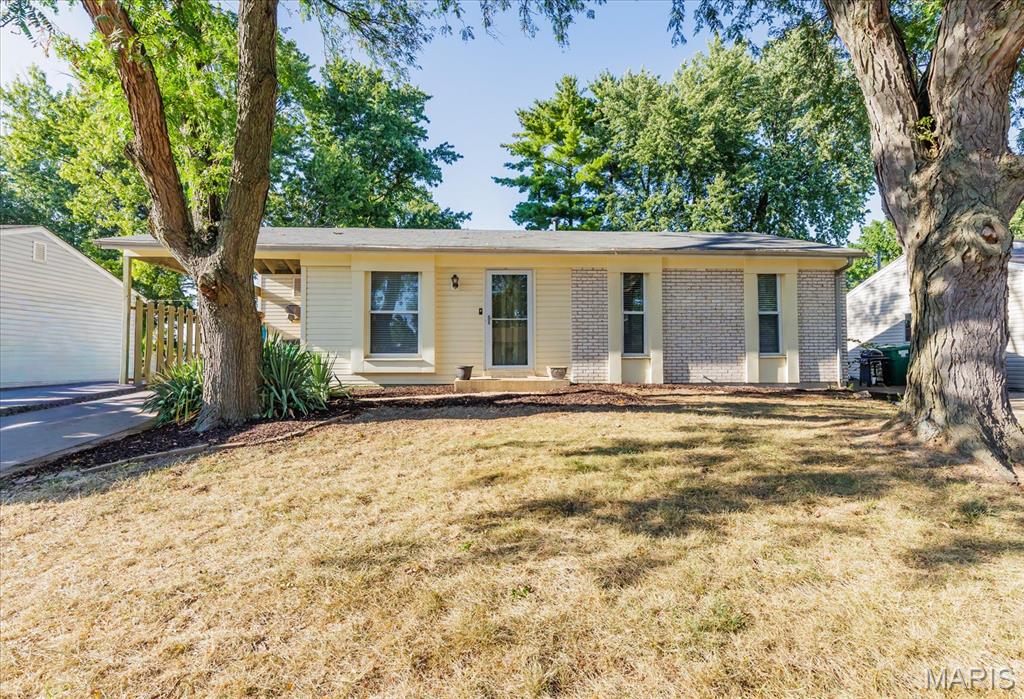 Welcome home to this charming 3-bedroom, 1.5 -bathroom ranch located in the heart of St. Charles! This meticulously maintained home features a spacious open floor plan, perfect for entertaining family and friends.  Fresh paint throughout interior and new carpeting in bedrooms.  The kitchen boasts granite countertop ON THE ISLAND, and ample cabinet space. The nice sized primary bedroom offers access to bathroom with walk-in shower via private door.  Extra living with cozy fireplace in the family room.  Outside, you'll find a large fenced yard with a covered deck, perfect for enjoying outdoor gatherings and barbecuing rain or shine. The home also features a carport and a full basement with large recreation room, bar and 1/2 bath.  Separate door leads to utility room for additional storage.  Located in a desirable neighborhood with easy access to shopping, dining, and highways, this home is perfect for buyers looking for convenience and comfort. Don't miss your chance to make this house your new home! Schedule a showing today.