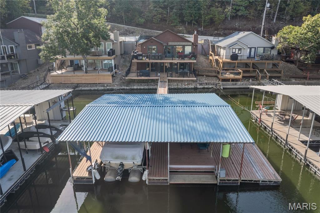 CHARMING 3BR/3BA RANCH WALKOUT AT THE 25MM W/ DOCK, WIDE LAKE VIEWS, & NEW SEWER SYSTEM COMING! Located in Sunrise Beach in a quiet, deep-water, no-wake cove, this turn-key lakefront home offers ideal full-time living or a getaway retreat!

PROPERTY HIGHLIGHTS:
• MAIN LEVEL LIVING: Bright open layout w/ hardwood floors, cozy fireplace, Pella doors, granite kitchen counters, & low-maintenance Trex deck.
• LOWER LEVEL: 3rd bedroom, 3rd bath, spacious family room, laundry area, & lower deck w/ just 3 easy steps to the dock walkway!
• DOCK & WATERFRONT: Private 1-well dock w/ swim platform & infinity steps (2nd well easily converted back). Wide main-channel views w/ calm cove protection!
• NEW TECH ENVIRONMENTAL SYSTEM: Seller is currently installing a cutting-edge environmental discharge system for top-tier efficiency & compliance!
• PARKING & ACCESS: Flat concrete parking pad for 4 vehicles (ready for future garage) + quick land & water access to hot spots.

Complete turn-key lakefront package priced to sell fast! Don't miss this slice of paradise—schedule a private tour or view the interactive Virtual Tour today!