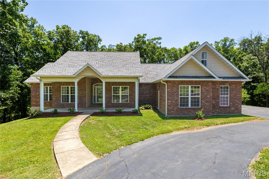 Welcome to 1170 Brickyard Rd, where privacy, space, and flexibility come together on 10.79 acres in Hillsboro. Situated on 5.58 acres and including an adjoining 5.21-acre wooded parcel, this property offers a rare opportunity to enjoy nearly 11 acres of beautiful Missouri countryside.

Inside, you'll find a thoughtfully designed floor plan featuring 3 bedrooms, 3 full baths, 2 half baths, a dedicated office, separate dining room, and two oversized bonus sleeping areas, providing plenty of room for guests, hobbies, remote work, or multi-generational living.

The beautifully updated kitchen is the heart of the home, featuring custom cabinetry, brand-new hard-surface countertops, newer appliances, and an impressive 8' x 4' walk-in pantry. Just beyond, the vaulted living room welcomes you with a wood-burning fireplace and abundant natural light.

The spacious primary suite offers two walk-in closets, private deck access, and an ensuite bath complete with a double vanity, jetted tub, separate shower, and private water closet.

The finished walkout lower level expands the living space with a large family room, gas fireplace, bar area, full bath, bonus sleeping area, 6' x 6' safe room, and abundant storage.

Step outside to enjoy the partially covered deck, covered patio, and peaceful wooded surroundings. The acreage offers a mix of mature timber and open areas, creating excellent opportunities for recreation, wildlife watching, and hunting.

Additional features include a 3-car garage, storage shed, dual electrical panels, new roof (2024), luxury vinyl plank flooring throughout the main level (2022), newer appliances (2019), HVAC heat pump replaced in 2024 and a water heater replaced in 2026.

Properties offering this much acreage, living space, storage, and flexibility are increasingly difficult to find. Don't miss your opportunity to make this private Hillsboro retreat your own.