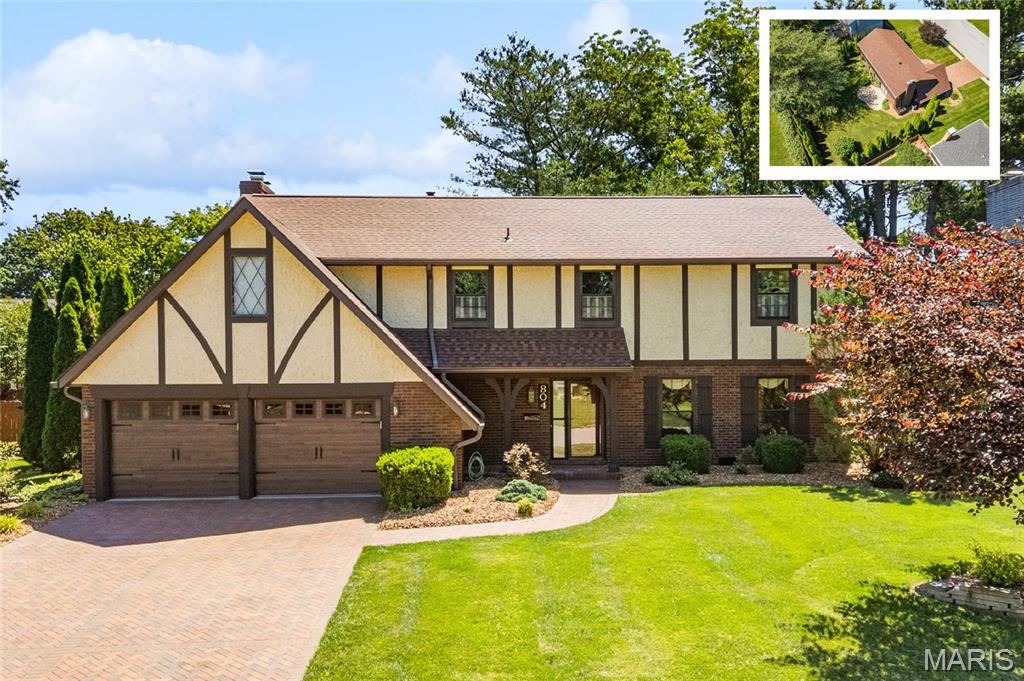 Wonderfully maintained 5 bedroom 3 bath home in O'Fallon District 90.  The pride in ownership is apparent as you approach the 2-story home.  A beautiful herringbone pattern paver driveway and sidewalk lead you to the mahogany front door.  Upon entry you notice hardwood floors throughout most of the main level.  A large living room and dining room lead to the spacious kitchen with custom cabinets, prep island, backsplash and under cabinet lighting. The kitchen opens to the family room featuring a beam ceiling and stone fireplace.  Sliding doors also provide access to the paver patio and level backyard.  The main level is complete with a laundry room and half bath. A wood staircase leads to the upper level where you find 5 bedrooms and 2 full baths. The primary suite is spacious and features a fireplace, large walk in closet and primary bath. The exterior of the home has received many updates including new garage doors (2025) as well as roof and gutters (2025).  Other features included: Pella windows, Lenox HVAC and professional landscaping.