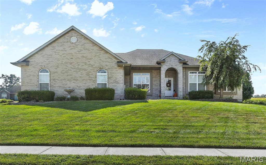 Stunning brick ranch in the Triad School District offers 4 bedrooms, 3 full baths and over 2700 sq ft of finished living space. It sits on a half-acre corner lot as you enter a cul-de-sac. Exterior features include a roomy 3 car garage w/ tall ceiling, a covered front archway porch with room for chairs, a stained & stamped concrete patio with a charming pergola just off the kitchen, AND another covered patio accessed from the walk out basement inside a fenced portion of the backyard.  Once inside, you will find tasteful matching LVP flooring continuous throughout the entire house, with the exception of carpet in one bedroom. An abundance of windows provides lots of natural light.  Just off the entry foyer is an open formal dining room with alluring columns, and straight back is the vaulted living room featuring a gas fireplace w/ impressive mantle & hearth.  Turn the corner to a large open eat in kitchen with a spot for a breakfast table, an abundance of counterspace, white cabinets (including a pantry cabinet), matching center island, and newer stainless appliances. There's also a handy built-in secretary station off to the side with more matching cabinets.  Main floor laundry room with cabinets & sink/vanity. Primary bedroom w/ trey ceiling easily accommodates a king size bed & furnishings. It has its own private luxury bathroom with jetted soaking tub, separate shower, dual bowl vanity, plus a walk-in closet.  Two other bedrooms and a full hall bathroom complete the main level. The walk out lower level has tall ceilings, is partially finished, & offers a recently added oversized family room. It's perfect for gatherings.  Also, a HUGE 4th bedroom (23x13) with large lookout window has been added. A full bathroom to serve the lower level and an enormous, unfinished storage room complete this tour !  Central Air (2024) Kitchen Appliances (2024 & 2025). Water softener included. Recently installed Govee Lighting System is included. Less than 30 minutes to Scott AFB.