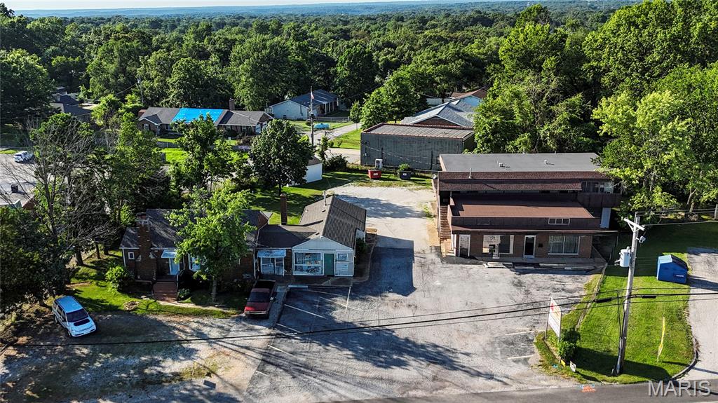 Great opportunity! 0.700 acres on the highly traveled High Ridge Blvd., the property includes a 3 bedroom/1.5 bath house with living space, an attached office, and another possible rental space for storage or other business.  Also, 2-two bedroom/one-bath apartments, 1-one bedroom/one bath apartment, 1-two bedroom/1.5 bath apartment, a beauty shop, an upholstery business, and a vacant office are included. Currently, the house is vacant, three apartments have month-to-month tenants, the beauty shop and upholstery business have month-to-month tenants. Showings will be scheduled for the vacant areas. Areas with tenants may be shown to clients preparing to submit a contract. The buyer may choose to allow the tenants to continue to rent or schedule the closing to allow one full month for tenants to move out. The home/property will be sold AS IS with no inspections or permits provided by seller. Many possible options to fulfill business goals.