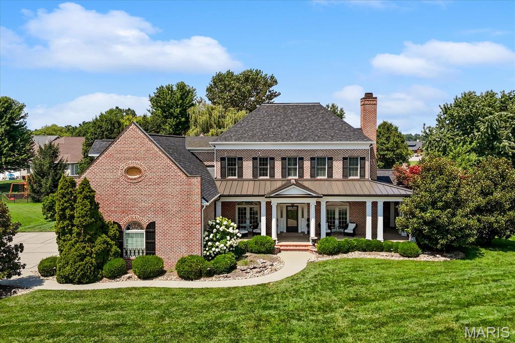 A beautiful custom built property in the Far Oaks golf course community that was also the Southern Living Idea Home of 2002. Taken straight from the Southern Living magazine, this is a breathtaking floor plan that combines southern grace with modern design. The front covered porch leads you inside to arched doorways, hardwood floors and soaring ceilings. The den has a gas fireplace, custom bookshelves on each side, and its own set of french doors to the covered front porch. The formal dining room also has patio doors leading to the covered front porch and leads into the gorgeous kitchen. The luxury kitchen also have newer counter tops and all appliances to stay including a freestanding gas range, built in microwave and another built in oven, double cabinet refrigerator drawers, and a walk in pantry. The breakfast nook also has a brick accent wall and leads into the stunning family room that has another fireplace, 24" ceilings, built in entertainment center, and french doors flanking the fireplace leading to the outside screened in living area with a refrigerator, built in grill, fireplace and tv.   The main floor primary bedroom comes with it's own laundry room, custom walk in closet, soaking tub, custom tiled shower and water closet.  Upstairs you'll find 5 more bedrooms (one used as a large play room/guest room with a walk in closet the other as a studio with it's own access to the outside and 1/2 bath great for multi generational living),  bedroom 2 and 3 share a jack and jill bathroom, and bedroom 4 has it's own full bath access. There is also a large laundry room along with another staircase leading back to the kitchen. The basement has a complete kitchen with a large island with granite tops, family room with all tv's to stay, recreation area off the kitchen, an exercise room with rubber flooring, 3/4 bath and the 7th bedroom with two sets of built in bunk beds and a large walk in closet.  Backing to the driving range, enjoy privacy in your heated inground saltwater pool that has an automatic pool cover and fountain feature. The expansive patio also has a built in fire pit.  There is still plenty of place to play behind the fence on the playset that will stay with the property.  And no need to find a pickleball court..  there is a painted court on the driveway! A stunning property all on over .5 an acre and in O'Fallon school district with a new roof! Buyer to verify all measurements and information.