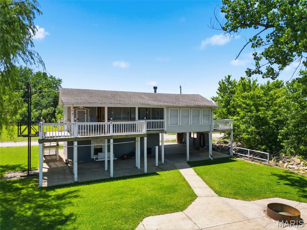 Wonderful riverfront home on the Mississippi River! This 2-bedroom, 1-bath property features a wood-burning fireplace, breakfast bar in the kitchen, and beautiful river views. The roof is approximately 8–9 years old, the steps are brand new, and the exterior elevator has a new motor. Enjoy two front decks: a private deck off the bedroom and a larger, partially screened-in deck overlooking the Mighty Mississippi. The property also offers a large patio with a fire pit and a spacious breezeway area, perfect for relaxing, entertaining, or enjoying the shade on warm summer days. Can use the breezeway area to park a car in too.  A storage area provides additional space for your outdoor gear and equipment. This property may be purchased with the property across the road for $159,900. The additional property is 0.35 acres and includes a 42' x 60' shed with a 14' door, 9' door, concrete floors, and 200-amp service. MLS#26035270