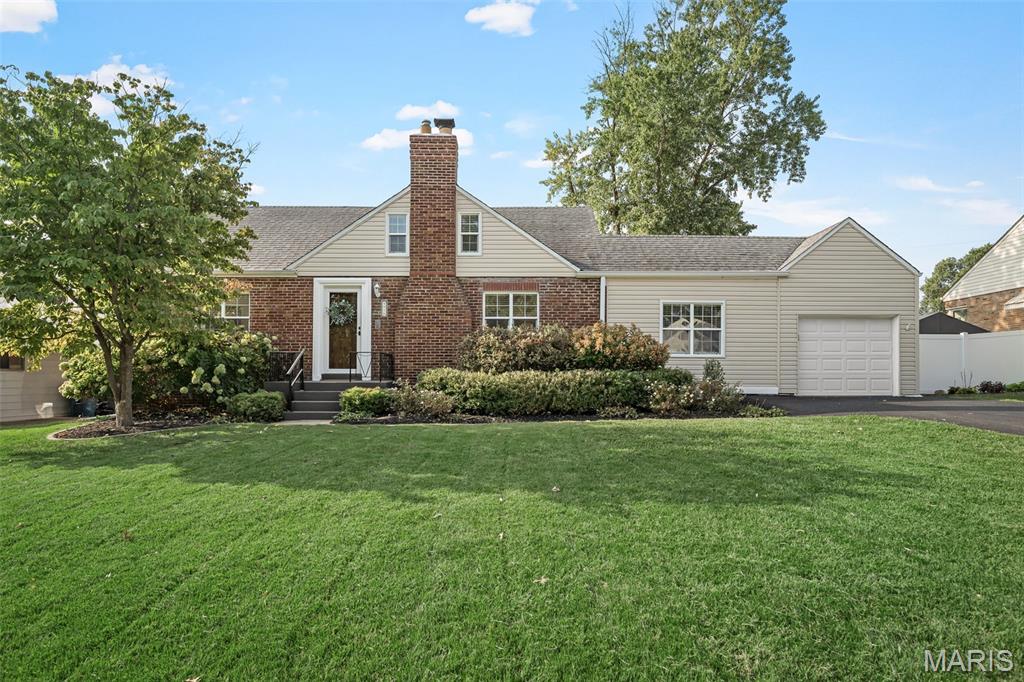 Timeless character & distinctive architecture come together in this darling Affton home. The unique front elevation and predominantly brick exterior sets the stage for the craftsmanship and thoughtful details found throughout. Inside, beautiful hardwood floors extend across the main level, complemented by gorgeous rich, wood doors, graceful arched doorways, new light fixtures in most of the rooms, and new, fresh neutral paint that allows the home's original character to shine.

The kitchen blends style and functionality with 42" cabinetry, granite countertops, stainless steel appliances, & an adjoining dining space. A charming bonus room showcases an exposed brick wall—a beautiful reminder of the home's history, as this space was likely once an open breezeway. Upstairs, additional living space can be found in the finished attic which was transformed into its own private living quarters, complete with a vaulted loft & bedroom, large walk-in closet, and full bath. Whether envisioned as a guest retreat, private sanctuary, home office, or separate space for family, this unique area offers possibilities rarely found in today's homes.

Two additional bedrooms and full bath are conveniently located on the main floor, along with a cozy family room showcasing a recently fully restored & functional wood-burning fireplace, while the full, clean basement offers excellent potential for future finishing & provides plenty of storage. Outside, the large, level, fully fenced backyard with patio provides is great for entertaining, gardening, play, or simply enjoying the outdoors. An attached one-car garage adds everyday convenience and the extra long, newly paved driveway provides additional off-street parking.

This is a property filled with warmth and architectural charm—where beautiful materials, distinctive spaces, and thoughtful updates come together in a way that feels relaxed & right at home. Ideally situated in a great Afton location close to everyday conveniences, this is a rare opportunity to own a home with updates & character!