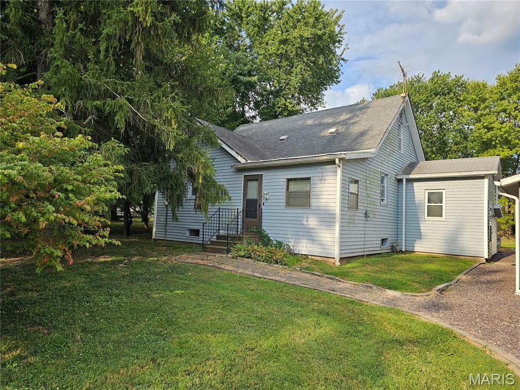 Come check this charming two-bedroom one-bath home situated on 1.65 acres, offering plenty of room to enjoy the outdoors and make the property your own. The main floor features a large eat in kitchen, comfortable living room and access to the heated  front porch, and a convenient mudroom. Upstairs , you'll find a large open area with plenty of cabinets that offer endless possibilities. Use it for storage, a private home office, a playroom, hobby space or potentially even an additional bedroom. The home also includes a basement with convenient access from the mudroom or inside the home with even more storage. Need room for vehicles, hobbies, or equipment? There's a two-car garage close to the home with garage door openers, plus 3 additional storage sheds. 24x26 -- 16x18--and 7x10. Come and take a look and see what you think! Call today to schedule your personal preview.