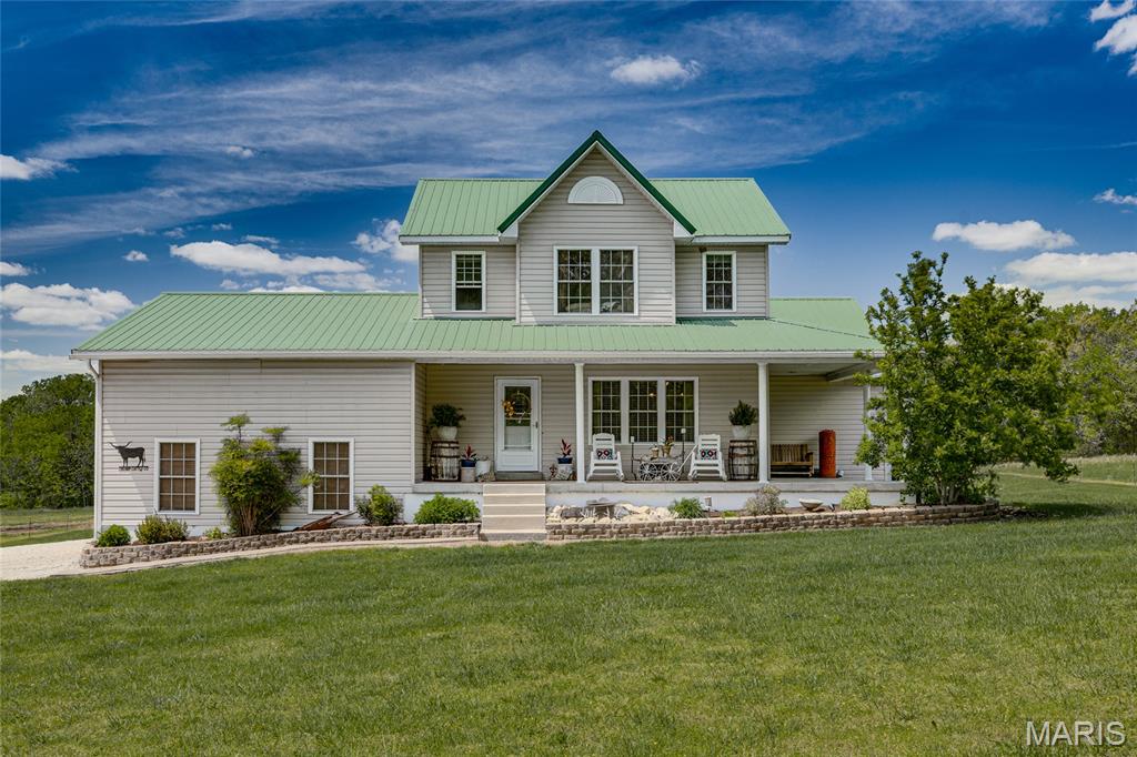 Peacefully nestled on over 20 acres, this gorgeous and practical home offers the perfect blend of comfort and outdoor living. The main level features a spacious primary suite creating a warm and inviting atmosphere.

Enjoy entertaining year-round with a covered outdoor living area, a beautiful two-level deck, above-ground pool, and a relaxing all-seasons room. The walk-out basement opens to a large patio space, ideal for gatherings or quiet evenings.

Upstairs, you’ll find a charming common area along with generously sized bedrooms, each featuring walk-in closets. The property also includes two smaller outbuildings for added storage or hobby use.

Nature lovers will appreciate the picturesque creek running all year round.... along the corner of the property, offering endless opportunities for recreation and peaceful scenery.