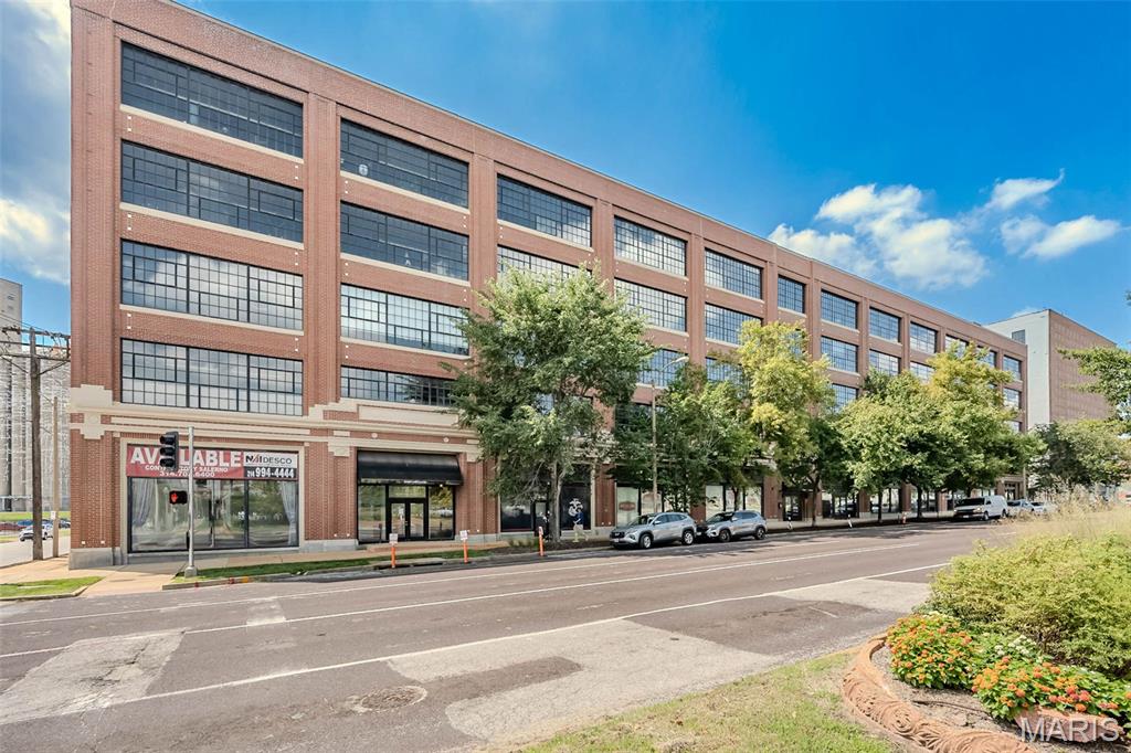 Set within the iconic West End Lofts - a former World's Fair-era Model-T Factory - this expansive residence delivers the perfect balance of historic architecture, modern updates, and unbeatable Central West End location. Inside, soaring concrete ceilings, exposed brick, original columns, wood floors and a coveted wall of windows create a dramatic yet inviting atmosphere filled with natural light. The open-concept living and dining area flows seamlessly into the kitchen, where Italian-inspired cabinetry, granite countertops, stainless steel appliances, breakfast bar and generous prep space make entertaining effortless. The spacious primary suite is a true retreat, featuring an oversized walk-in closet and a spa-inspired bath with dual vanities and a luxurious oversized shower. A second bedroom and full bath provide flexibility for guests, office space, or everyday living. The convenient in-unit washer and dryer is included in addition to one secure parking space.  Enjoy an exceptional array of amenities, including a large inground pool, fitness center, guest suite, billiards room, elevator, secure gated parking, and updated lobby spaces. The pet-friendly building offers a truly easy lifestyle, with the condo fee covering everything except electricity. Ideally located in the vibrant Central West End, just moments from BJC, SLU, WashU Medical Campus, Cortex District, The City Foundry, Forest Park, plus an abundance of restaurants and cafes. Urban sophistication, historic character, modern design and an unbeatable location all come together in this exceptional loft residence.