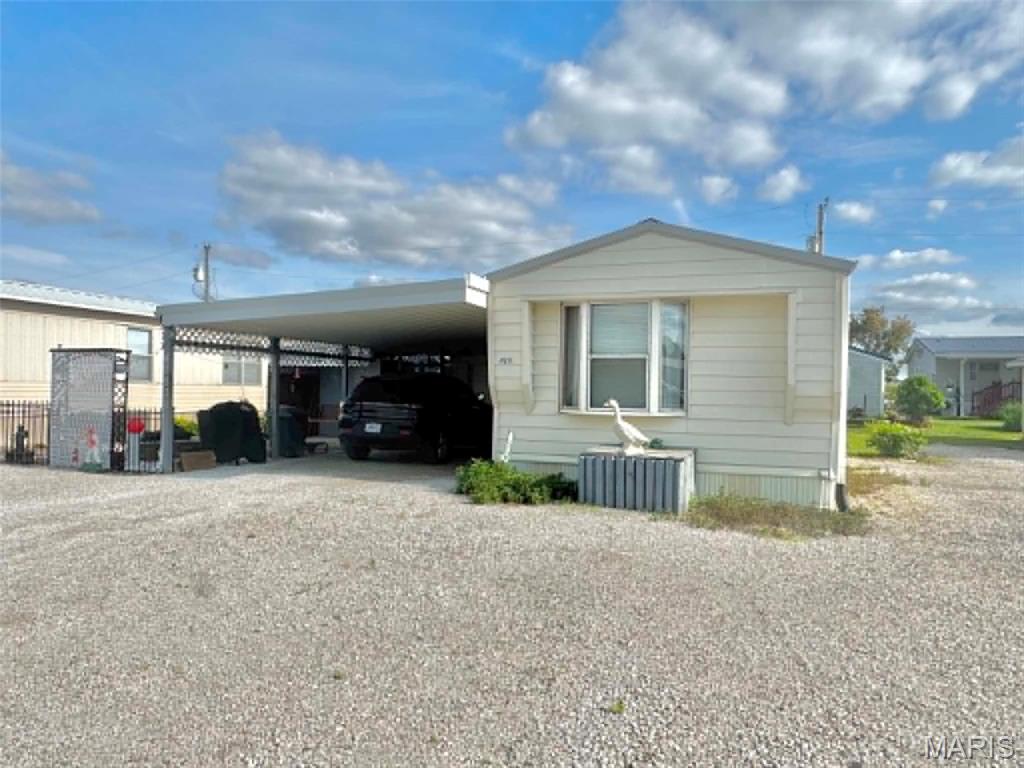 Escape to lake life with this charming 2-bedroom, 1.5-bath manufactured home just minutes from Mark Twain Lake! Featuring an inviting open floor plan, this home offers comfortable living whether you're looking for a weekend retreat or a full-time residence. Outside, you'll find plenty of extras including a detached garage with attached carport, additional storage shed, and a storm shelter for added peace of mind. Relax around the firepit or unwind on the patio while enjoying peaceful evenings and star-filled skies. A perfect place to gather, relax, and enjoy all the recreation the lake area has to offer!