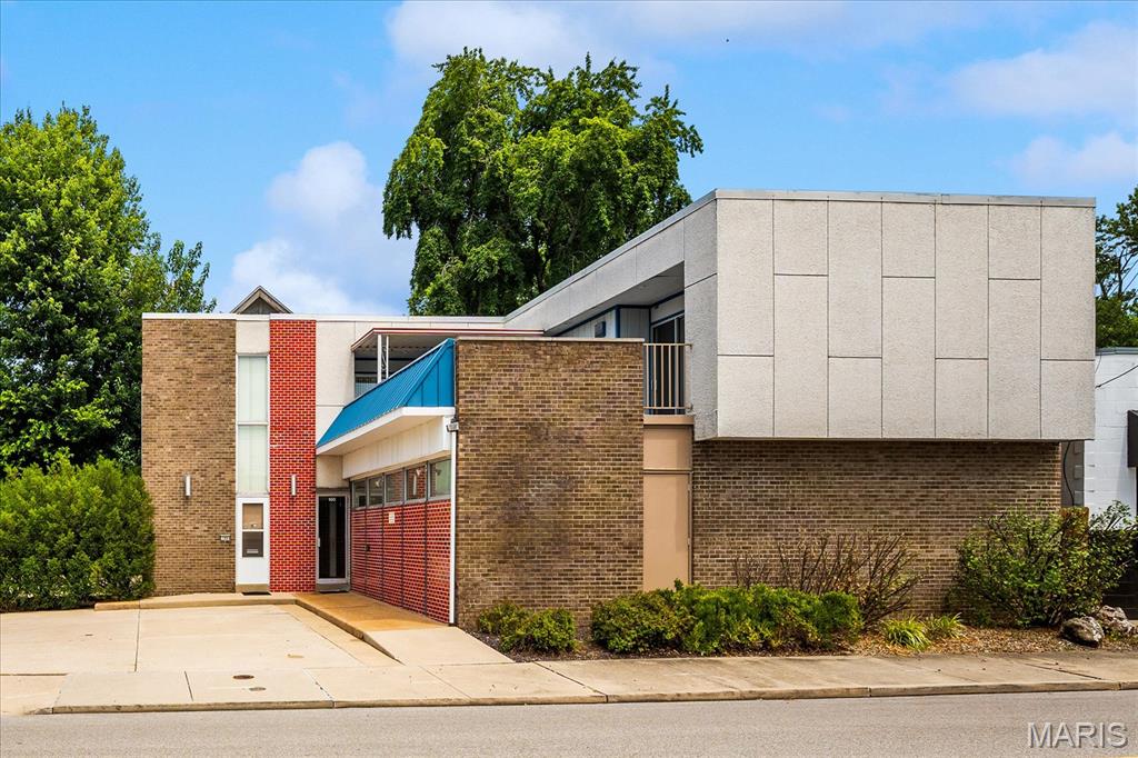 A truly one-of-a-kind opportunity in the heart of Downtown Belleville! This remarkable mixed-use property seamlessly blends commercial functionality with an exceptionally well-preserved 1970s architectural masterpiece. Whether you're looking for a live/work environment, investment property, boutique office, creative studio, or a space with endless redevelopment potential, this building offers possibilities that are nearly impossible to duplicate. The main level features professional commercial office space with outstanding street presence, while the lower level provides abundant storage, a two-car garage, and a unique dumbwaiter designed to transport groceries and other items directly to the second-floor living quarters. Above it all is an extraordinary private residence that feels like stepping back into the golden age of modern design. The second floor offers 3 bedrooms, 2 bathrooms, dramatic open living spaces, an iconic floating staircase, a private spiral staircase, and countless original architectural details that have been beautifully preserved. Every room celebrates the bold design elements that made 1970s contemporary architecture so distinctive. One of the home's most captivating features is the expansive private courtyard and patio overlooking Downtown Belleville. Whether enjoying your morning coffee, entertaining guests, or taking in an evening concert from the city below, the panoramic views create an unforgettable setting unlike anything else in the area. From its timeless architecture and unique design features to its unmatched flexibility and downtown location, this is more than just a property -it's a landmark waiting for its next chapter. Properties of this caliber and character rarely become available. Schedule your private tour and experience this architectural gem for yourself. (58 spaces for public parking are located directly across Mascoutah Ave)