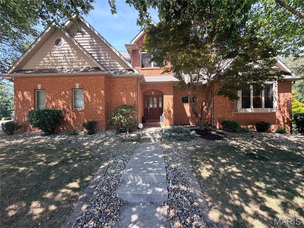 Offered for the very first time, this exceptionally crafted home was custom-designed by its architect owner, blending intelligent design with breathtaking natural surroundings. Nestled at the corner of a quiet cul-de-sac on a lush 0.79-acre lot, the home features a wall of rear-facing windows that make you feel like you are living in a luxurious, secluded treehouse. The main level boasts a grand foyer that opens into a great room and dining area with soaring two-story cathedral ceilings. The adjacent entertainer’s kitchen is custom-built for hosting with gorgeous cabinetry, appliances and counters, and features a large breakfast bar, an informal dining area, and seamless access to a massive deck overlooking the tree canopy. The main-floor primary suite is a true retreat, offering vaulted ceilings, floor-to-ceiling windows, a massive walk-in closet, and a spa-like en suite with a jetted soaking tub, separate shower, and dual vanities. Rounding out the main floor is a half bath and a laundry room that connects to an oversized two-car garage with a dedicated workshop.
Upstairs, an elegant open staircase leads to a sunlit landing—perfect for a cozy reading nook or study. Two generously sized bedrooms share a large full bath with dual vanities and a separate water closet. A delightful surprise awaits in one of the bedrooms: a secret room, complete with a built-in bench seat and a charming round window, hidden away and accessed exclusively through the walk-in closet!
The fully finished walkout lower level is an entertainer's dream. It features a sprawling recreation room complete with a billiards table and cozy corner fireplace, a separate custom bar and lounge, an exercise room (or bonus room), a full bath, a utility room, and massive storage space. Step outside to a covered patio that leads down to a stunning recessed, paved fire pit area. The professionally landscaped, wooded backyard gently slopes down to a peaceful creek, complete with your own private bridge. This architectural oasis is truly one of a kind!