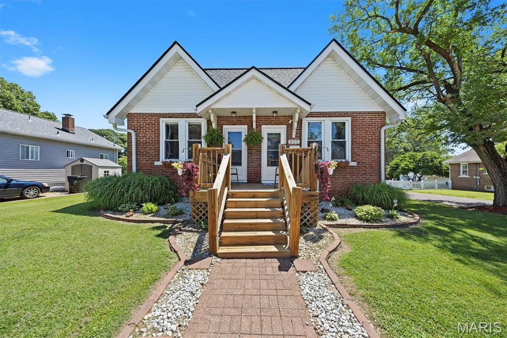 Welcome home to this well-maintained all-brick bungalow offering space, functionality, and a convenient location! Situated on a desirable corner lot, this charming home features inviting curb appeal with a welcoming front porch, a newer roof for added peace of mind, a concrete driveway with convenient off-street parking, and a fenced backyard complete with a storage shed for extra convenience.
Inside, you’ll love the spacious layout featuring a large living room that is adjacent to an additional family room or office space—perfect for working from home, a second living area, or flexible living space to fit your needs. Both rooms feature wood flooring and tall windows offering plenty of natural light.  The oversized eat-in kitchen is ideal for both everyday living and entertaining, offering abundant space, a breakfast bar, and stainless steel appliances, including an electric range, refrigerator, and dishwasher.
The home offers three comfortable bedrooms, two full bathrooms, and an exceptionally large laundry room complete with built-in cabinetry and sink. The finished lower-level recreation area provides excellent bonus living space for entertaining, hobbies, or a playroom, while the unfinished basement area offers plenty of additional storage.
Conveniently located near schools, shopping, dining, Highway 15, Downtown Belleville, and just a short commute to Scott AFB or Downtown St Louis, this move-in ready home offers the perfect combination of space, comfort, and convenience!