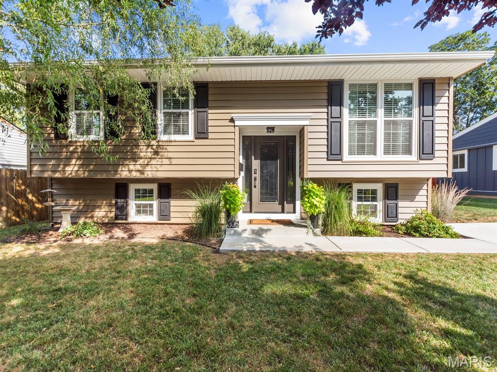 LUXURY UPDATES IN O'FALLON! You will LOVE everything about this home! Over 1,600 sq ft of finished space, meticulously updated with a modern and cozy feel. Beautiful entryway with hardwood floors and custom steel and wood trim stairway to create an open feel and updated look. The hardwood flooring carries throughout the open living room, which is beautifully painted and accented with recessed lighting for a clean and modern space. Open floor plan to the kitchen and dining area. Kitchen features beautiful tile backsplash and stained cabinetry, LED accent lighting, plus easy access to the deck, perfect for entertaining. Lower level has great flexibility with a large 4th bedroom with its own private updated half bath.  Additional living space in the lower level family room, and laundry room that includes plenty of storage shelves.  Don't overlook the attention to detail in this remodeled beauty, both inside and outside. Vinyl siding has 1.5 inch insulated backer for extra durability and insulation value, plus the whole front siding was just replaced in 2026, as well as the upgraded high-efficiency vinyl windows in the front that have a transferable warranty. Also new in 2026: fascia, gutters, and front shutters too. Roof, driveway, and fence, all new in 2025.  The current owners have updated the following since they purchased the home:  electrical panel, all siding, windows, front door, flooring, bathrooms, paint, and SO MUCH MORE! Since 2010 this home has been completely rehabbed, and it looks like it was just completed. You will also enjoy the excellent location with easy access to Illini Walking Trail, the fabulous Downtown District, O'Fallon Family Sports Park, shopping, restaurants, and Hwy 64 for all that St Louis has to offer! Call your favorite Realtor for a tour today!