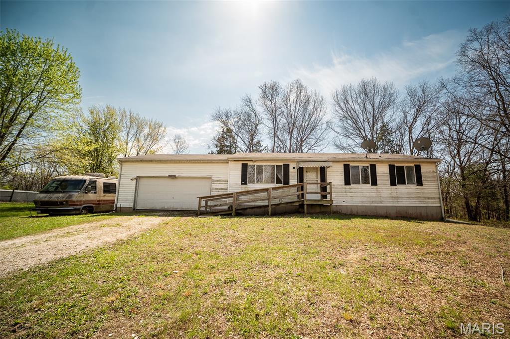Opportunity awaits with this 3-bedroom, 1-bath ranch situated on a spacious 1.28-acre lot! Being sold as-is, this home offers solid bones and endless potential for investors, rehabbers, or buyers looking to build instant sweat equity. The functional floor plan is ready for your vision and updates, while the oak kitchen cabinets provide a great starting point for a renovation. The unfinished basement features a bathroom rough-in, creating the perfect opportunity to add additional finished living space and a second full bath. Major improvements include an updated PVC plumbing stack, giving peace of mind as you tackle the cosmetic updates. Outside, you'll find a two-car garage, a rear deck, and plenty of room to spread out and enjoy the privacy of over an acre. Whether you're searching for your next flip, rental investment, or a place to customize into your dream home, this property is packed with potential. Bring your ideas and unlock the value this hidden gem has to offer!