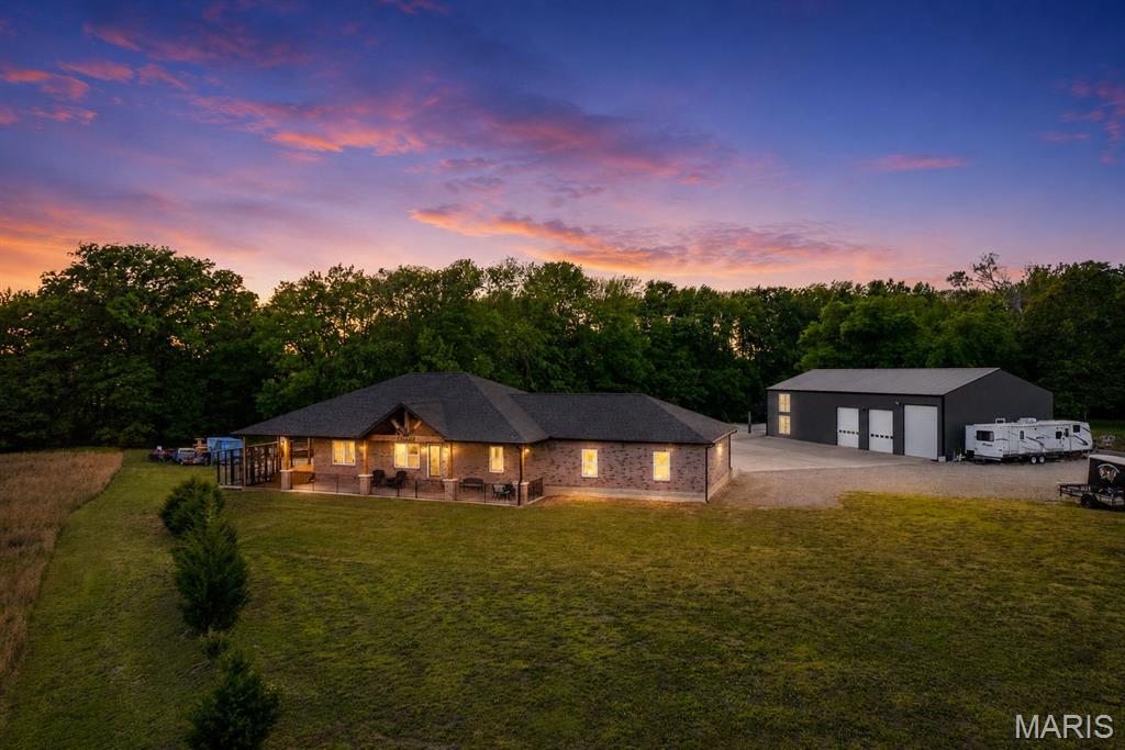 Stunning 3-year-old, all brick home on 5 acres with heated shop and apartment. Discover the perfect
blend of luxury, space and functionality in this beautifully built 1620 sq. ft. all brick home, ideally located
just 2 miles from Gordonville on highway 25. Set on 5 scenic acres, this property is packed with high-end
features inside and out.
The main level oUers 3 bedrooms, 2 ½ baths, quality hardwood and ceramic tile flooring throughout, and
a thoughtfully designed kitchen highlighting custom S&W Knotty Alder cabinetry, granite countertops with
diamond glass backsplash, and a striking leather granite island. An upgraded gas range and stainless-
steel appliances complete the space.
The primary suite features a custom 4’X6’ walk in tiled shower with body sprays, rain head, handheld
shower, plus walk in closet. All bathrooms include custom mirrors with fog settings, and the hall bath
oUers a relaxing jacuzzi tub with blue tooth speaker.
Additional living space includes an 11’X14.5’ oUice or sleeping room in the basement, rough plumbed for
a future fourth bath, and an impressive 30’X44’ basement garage with tesla charger and welder plug in.
The 30’X30’ attached garage is fully finished and Tesla chargers and welding plug in are installed for
modern convenience, also four separates 20 am plug ins for garage refrigerator or deep freezes.
The property truly shines with its 3200 sq ft. heated, three-bay shop, built with 2X6 insulated walls, spray
foam ceiling insulation, and HAVCO boards along side walls. Doors included one 14’X12’ door and two
12’X10’ doors, oUering plenty of room for equipment or vehicles. The shop is fully wired with outlets of 8
ft and includes two dedicated 20-amp circuits for band or specialty use, including multiple welding plugs,
a tesla charger and prewired for two post car lift.
Above the shop is an 800 sq ft heated and cooled apartment with two bedrooms, one bath, and a storage
room ideal for guests or additional income.
There is also an 800 sq ft heated and cooled bar/kitchen area featuring a stunning 20’ custom wood bar,
plus a separate bath and utility room. Outside the bar is a 20’X40’ covered seating area.
Additional features include.
Solar Power, propane gas heat, septic system, county water, SEMO fiber internet, 50 Amp RV plug in
No Covenants or restrictions
This one-of-a-kind property oUers exceptional versatility perfect for homeowners, hobbyists, private
venue, or business owners looking for space, comfort, and quality construction. Apartment currently rented $1,000 month.  No covenants, 3 bay (1) 14x12, (2) 12x40 doors.  Work at shop & live in beautiful home!  Duplicate listing of MLS #26027785.