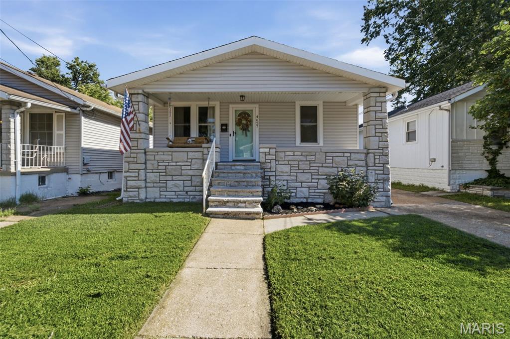 Charming Affton bungalow with character, flexible space and a backyard made for enjoying! From the moment you arrive, the covered front porch welcomes you with a classic porch swing—the perfect spot for morning coffee or relaxing at the end of the day. Inside, the living room is warm and inviting, featuring the home's original wood-burning stove and plenty of space to gather.

The kitchen is conveniently located just off the living room. A small porch just off the kitchen provides extra storage and leads to the  expansive backyard. The main level offers two comfortable bedrooms and a full bathroom.

The walk-up lower level adds even more versatility with a full bathroom, laundry area and two additional finished rooms, each with a closet.  Use the extra rooms however they best fit your lifestyle—home office, hobby room, workout space, playroom, media room or additional storage. Washer and dryer stay!

Outside, you'll love the flat .21-acre lot and spacious backyard, offering plenty of room for entertaining, grilling, gardening, playing or simply enjoying the outdoors. A storage shed provides a convenient place for lawn equipment, tools and outdoor belongings. There’s also off-street parking with a driveway, plus room to build your own garage down the road if you’d like.

Conveniently located near Gravois Road, shopping, restaurants, everyday conveniences and major highways, this home offers the best of having what you need close by while still enjoying a comfortable residential setting. Cute, comfortable and full of possibilities, 4627 Tiemann Avenue is ready for its next chapter! Property is being sold "As-is" and Seller will make no repairs or improvements as a condition of sale.