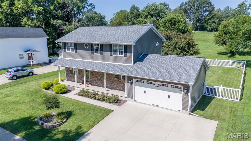 Prepare to be impressed by this stunning home in the heart of Vandalia! Offering 2,268 square feet of finished living space, this meticulously maintained home features four spacious bedrooms, three full bathrooms, and an additional half bath, providing plenty of room for family and guests. The backyard is truly magazine worthy, featuring a beautiful covered patio that's perfect for relaxing or entertaining, a fenced yard, and mature trees that provide both shade and privacy. Inside, the kitchen is sure to impress with hard surface countertops, gorgeous cabinetry, and stainless steel appliances. The inviting living room offers brand new carpet and a cozy gas fireplace, creating the perfect place to unwind on chilly evenings. Upstairs, you'll find the spacious primary suite along with three additional bedrooms and another full bathroom, offering a functional layout for today's lifestyle. Major updates include a brand-new roof and siding installed in 2025, adding peace of mind for years to come. Homes of this caliber and condition rarely become available in Vandalia. Don't miss your opportunity to make this exceptional property your own, schedule your private showing today!