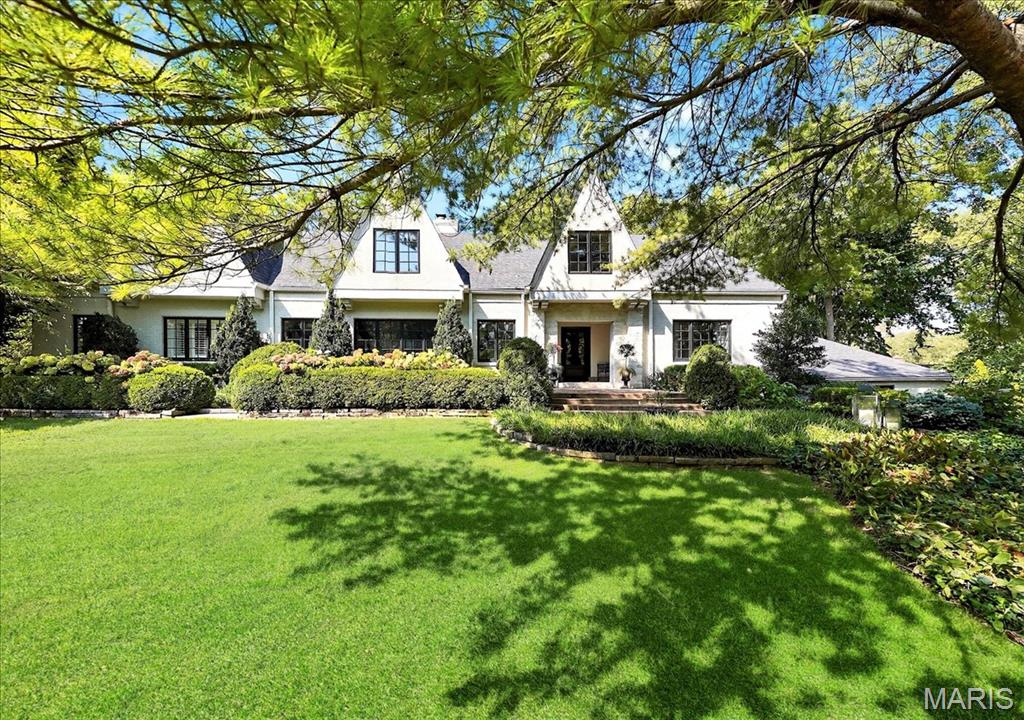 1930’s dream home tucked away on a quiet, no outlet street in Ladue, this beautiful Lay Road home offers 6220 sq ft of elegance and modern luxury.  Completely remodeled in 2022, the home won the 2022 Home Builders Association Remodel Kitchen Award featured in both Ladue News and Town & Style Magazines - a true Beck/Allen showpiece. It boasts custom cabinetry w/lead glass fronts, a 10’ x 5’ center island breakfast bar, butler’s pantry, wet bar w/wine tower, beverage refrigerator, & commercial-grade Wolf, Sub-Zero, & Miele appliances. The gracious foyer w/opened staircase opens to an expansive living room w/stone fireplace & a spacious dining room. The hearth room, w/exquisite box-beam millwork & gas fireplace, creates a sophisticated yet inviting gathering space. The main level also includes a luxurious primary suite w/dual walk-in closet, a spa-inspired bath, a study w/wall of built-ins, a new laundry room w/dog shower 2022, & new guest bath 2022. Upstairs, a barreled-ceiling hallway leads to a grand family room, 4 additional bedrooms, 2 full baths, & versatile flex spaces. Outdoor living is equally impressive w/a sprawling deck overlooking the manicured, fenced almost 1-acre grounds & sparkling pool. Recent upgrades & features include new architectural roof 2025, HVAC systems 2022 & 2025, added & refinished hardwood floors 2022, insulated wood windows & extensive millwork throughout. Impeccably finished & thoughtfully curated, this home offers the pinnacle of Ladue living.