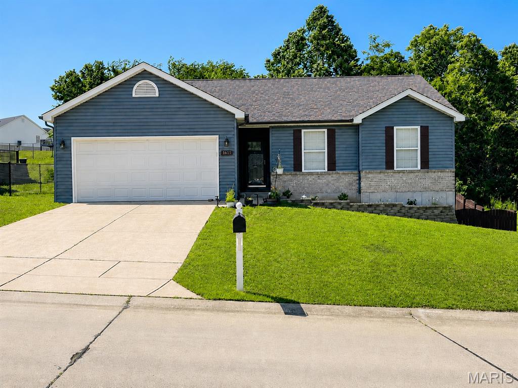This updated ranch in the desirable Hillsboro School District has a lot going for it before you ever get inside — great curb appeal, tasteful landscaping, stone retaining walls, freshly stained privacy fencing, a concrete driveway, partial brick front, updated slate-blue siding, and a newer architectural roof.

The main level is clean, fresh, and move-in ready with an open-concept layout, new luxury vinyl plank flooring throughout, white trim, modern colors, and a cozy wood-burning fireplace in the living room. The kitchen features white cabinets, granite countertops, and easy access to the poured concrete porch just off the kitchen. The primary suite includes its own full bathroom and walk-in closet, and the home offers 4 bedrooms and 3 full bathrooms total.

You’ll also appreciate the comfort and peace of mind provided by the 2-car attached garage, Generac backup generator serving select areas, battery-backed sump pump, and side walkout basement.

But the lower level is where this home really separates itself from the typical ranch.

The finished walkout lower level is set up as a luxury private apartment, complete with its own full kitchen, living room, bedroom, full bathroom, and a huge custom walk-in shower that feels far more upscale than what you normally find in a lower level. With the side walkout access, this space works incredibly well for extended family, guests, older kids, in-laws, multi-generational living, or just an awesome private hangout area.

It is rare to find a ranch that is this updated on the main level and also offers such a complete, high-end lower-level living space. This one is definitely worth a look.