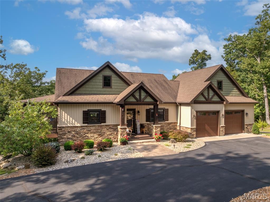 From the moment you arrive, this custom-built cottage makes a great first impression. Built in 2016, this three-bedroom, two-and-a-half-bath home offers the ideal balance of manageable size and comfortable living space. Whether you’re looking for a weekend escape or a full-time residence, this one delivers plenty of room to relax, entertain, and welcome family and friends. The approach is beautifully landscaped and leads to a newly installed paver walkway. Step through the front door and you’ll immediately feel at home. The main level features an inviting vaulted living room with a gas fireplace framed by windows overlooking the private wooded setting. Just off the living room is one of the home’s favorite gathering spots, the screened-in porch. It’s the perfect place to unwind and listen to the soothing sound of the water feature outside. Beyond the porch, a striking koi pond adds another layer of tranquility to the setting! The kitchen is designed for both everyday living and entertaining. Custom cabinetry, granite countertops, and stainless steel appliances give the space a polished feel. The refrigerator was replaced in 2025. Gather around the generous center island, pour a drink, and let the conversation continue while dinner is being prepared. The main-level primary suite is a relaxing retreat of its own. A wall of windows bring in natural light. The spacious walk-in closet provides excellent storage, while the upscale bathroom features a tiled walk-in shower and double vanity. A convenient half bath and laundry room round out the main level. Washer and dryer included! Downstairs, the finished lower level gives more room to spread out. The family room is made for movie nights or big game days. Two generously sized bedrooms provide comfortable accommodations for overnight guests. A full bathroom and separate storage room add even more convenience. Step outside and the entertaining continues. The patio has plenty of space for a table and chairs, making it easy to fire up the grill and enjoy dinner outdoors. A separate patio was designed specifically for a hot tub and is already prewired and ready to go. And wherever you are in the yard, you can hear the gentle, bubbling sound of the water feature. The fenced yard is ideal for dogs, while the storage shed provides a handy spot for lawn equipment and outdoor gear. The thoughtfully designed landscaping is both attractive and lower maintenance, giving you a great outdoor setting without demanding endless upkeep. The oversized garage is another standout feature. It was built to comfortably accommodate two vehicles plus a golf cart. The home is also wired for a generator, and a generator is included with the sale. A circular blacktop driveway makes arrivals and departures easy, with plenty of room for guests. Some furniture and décor is available for purchase separately, offering an opportunity to make this turnkey retreat even easier to enjoy. The Lake Alpine boat launch and Lake Kitzbuhl sand beach are both just minutes away, making it easy to enjoy all that Innsbrook’s lakes have to offer. With its inviting interior, wooded setting, exceptional outdoor spaces, thoughtful updates, and room for family and friends, this Innsbrook home is ready to be enjoyed in every season. Come take a look and see how nicely it all comes together.