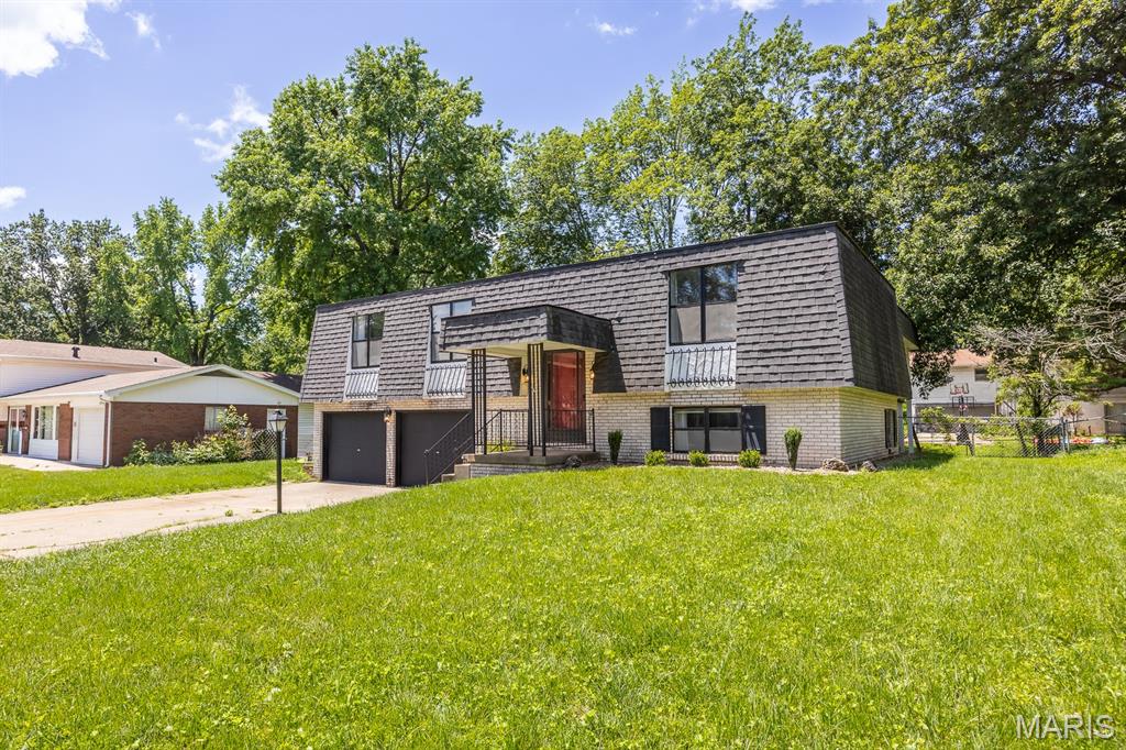 Welcome Home! This gorgeous split level is updated and ready for you! Full of character, comfort and timeless appeal. 
Upstairs you will find an inviting family and dining area. Step outside to the fun martini deck where you will spend relaxing evenings! You will also find comfortable bedrooms space and an updated bath. Your vintage downstairs great room makes a perfect 2nd entertaining space! Loads of updates including flooring, appliances, light fixtures, paint and so much more! 
Call your favorite Realtor and Schedule your appointment today!