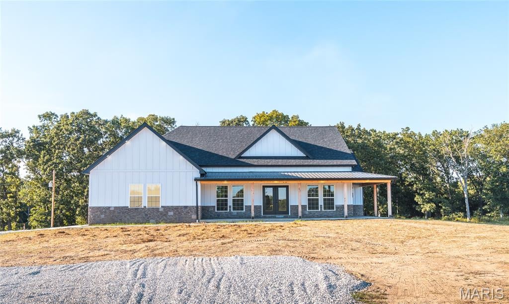 NEW CONSTRUCTION | MODERN FARMHOUSE ON 3+/- ACRES

Welcome to 21875 Vineyard Outer Rd in St. James, MO! This beautiful new construction modern farmhouse offers the perfect combination of modern style, thoughtful design, and peaceful country living, all situated on approximately 3 acres with beautiful wooded views.
This 3-bedroom, 2-bathroom home features an inviting open floor plan with beautiful coffered ceilings, creating an elegant yet comfortable atmosphere throughout the main living areas. The stylish kitchen is designed for both everyday living and entertaining, featuring solid-surface countertops, a center island, and durable LVP flooring.
The spacious master suite offers a private retreat, complete with a walk-in tiled shower and plenty of room to relax and unwind.
Enjoy the beauty of the outdoors from the covered front and back porches, perfect for morning coffee, entertaining, or simply taking in the surroundings.
The walkout basement is a blank canvas, offering endless possibilities for future finished space. Whether you envision a recreation area, home office, guest space, or additional bedrooms, there's plenty of room to make it your own. 
The walkout leads directly to the backyard, where you'll enjoy beautiful views overlooking the woods.
This property offers the perfect opportunity to enjoy country living, without sacrificing modern comforts. Call today for your private showing!