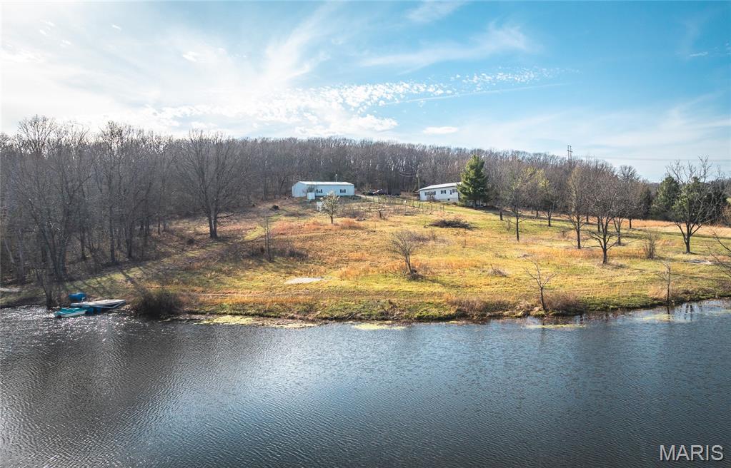Sellers are installing a complete new sewage system prior to closing, offering added peace of mind and long-term value. Escape to the beauty of the Ozarks with this stunning 21.7 ± acre property in Osage County, offering the perfect blend of recreation, comfort, and natural charm. At the heart of the property lies a breathtaking 3-acre lake—ideal for fishing, swimming, or simply relaxing on the dock and taking in the peaceful surroundings. The land is predominantly wooded, creating a private sanctuary teeming with wildlife, including deer, turkey, and quail, making it a dream for hunters and outdoor enthusiasts alike. A scenic hillside adds character to the property and is home to a diverse array of fruit-bearing trees and plants, including apple, peach, apricot, wild plum, walnut, hazelnut, and more—perfect for those who appreciate homegrown harvests and a self-sufficient lifestyle. The 1,600 square foot home features 2 bedrooms and 2 bathrooms, offering comfortable living with picturesque views of the surrounding landscape. In addition, there is an extra room that can be used as a home office, hobby space, or guest room, adding flexibility to fit your needs. The property also includes a designated spot for RV parking, making it ideal for hosting visitors or accommodating your own travel lifestyle. Whether you’re looking for a full-time residence, weekend retreat, or recreational getaway, this property delivers endless opportunities to enjoy the great outdoors. A true Ozarks paradise where you can hunt, fish, swim, and unwind—all right out your back door!