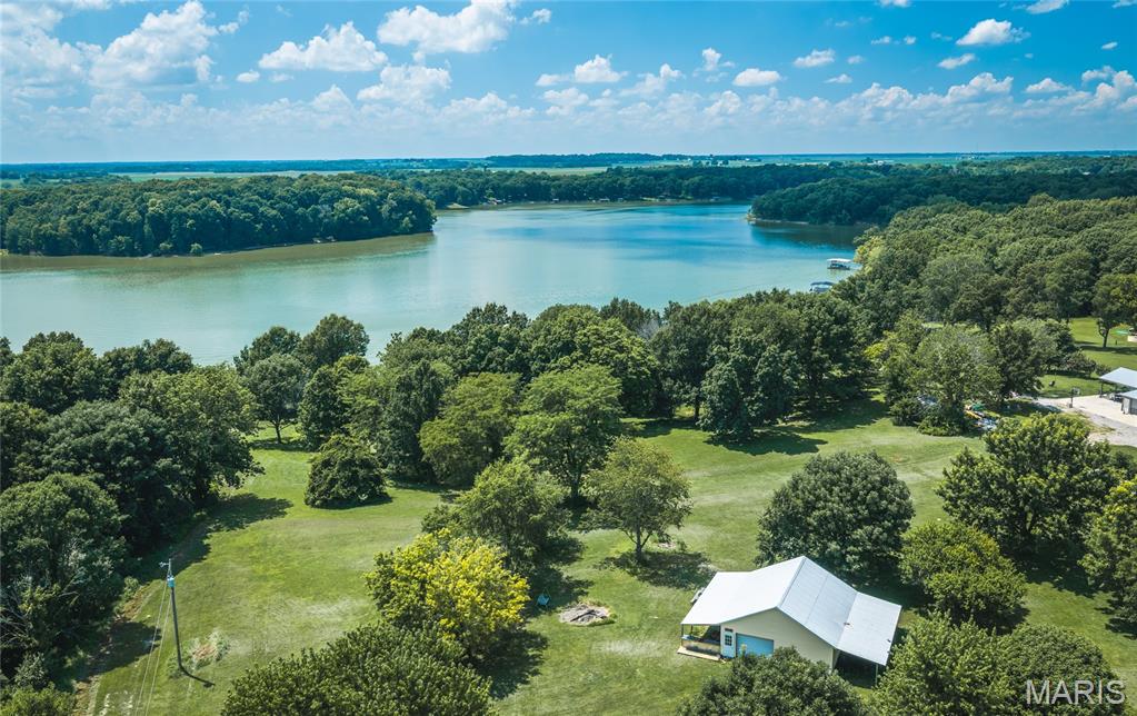 ONLINE AUCTION 08/22/2026 at 8am - 08/31/2026 at 1pm

Welcome to paradise! Located just north of Hillsboro in Montgomery County, Illinois, this exceptional 5± acre lakefront property offers a rare opportunity to own a premier piece of waterfront real estate on the beautiful 1,250± acre Lake Glenn Shoals.

Boasting approximately 300 feet of shoreline, this property features an outstanding elevated homesite with breathtaking lake views, making it an ideal location to build your dream home or weekend retreat. Whether you're looking for a permanent residence or a recreational getaway, this property offers endless possibilities.
Tucked away in a peaceful, secluded setting on a dead-end private road, this property provides the privacy and tranquility you've been searching for while remaining conveniently located approximately 40± miles from Springfield and 50± miles from St. Louis. 

Also situated on the property is an approximate 30' x 30' metal-sided shed with double lean-tos on each side, providing ample storage for boats, ATVs, equipment, and recreational gear. Electric and Water are on site.

With its combination of exceptional building potential, scenic lake frontage, abundant wildlife, and unmatched recreational appeal, this blank canvas is ready for new ownership. Create a legacy of unforgettable memories with family and friends on one of central Illinois' most desirable lakes. Properties like this rarely become available - don't miss your opportunity to make this exceptional Lake Glenn Shoals property your own!