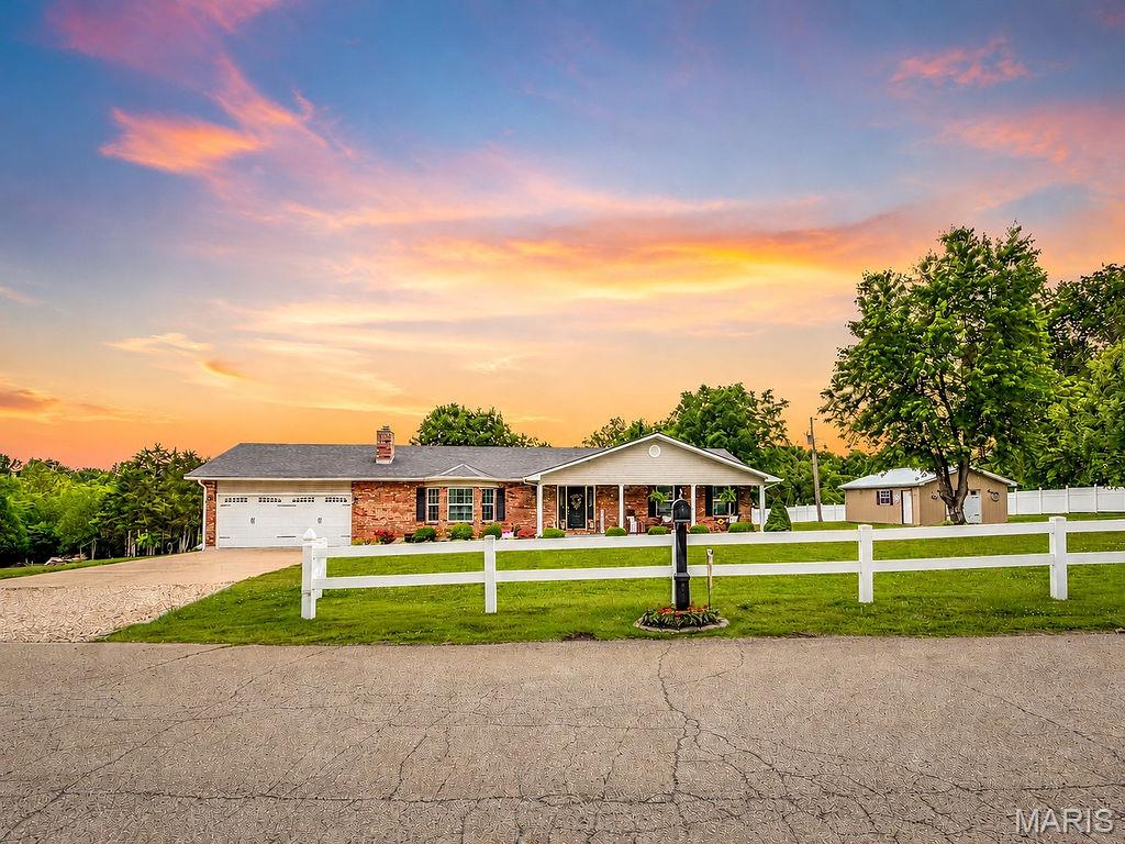 Welcome to your ultimate dream property on Hulsey Road! Nestled on 4.2 beautiful, sprawling acres in Park Hills, this stunning all-brick ranch offers over 2,100+ square feet of immaculate one-level living space. From the moment you pull up the long sidewalk and take in the pristine landscaping , you'll know you are somewhere special.
Step inside to an expansive, open layout featuring gorgeous hardwood floors flowing seamlessly through multiple living areas. The heart of the home is a massive country kitchen fully equipped with rich wood cabinetry, stainless steel appliances, and a massive breakfast bar island. Retreat to the sprawling master suite, a true private oasis complete with an elegant tray ceiling and an attached ensuite bath.
If you love the outdoors, prepare to be amazed. The back of the home boasts a bright, breezy screened-in sunroom  that opens up to a huge, sprawling wooden deck perfect for entertaining, barbecuing, or watching the kids splash in the pool.
Got hobbies? This property is a rare find, featuring an attached, pristine 2-car garage, a large standalone detached workshop, and a charming red storage shed secured within a beautiful white vinyl privacy fence. Don't miss your chance to own this rare slice of acreage and luxury!