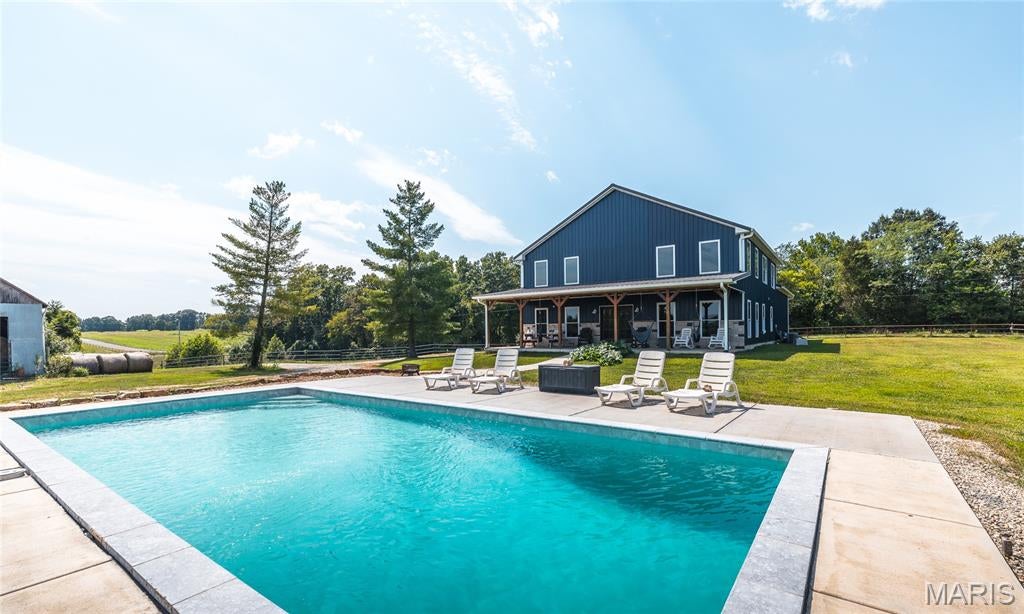 ONCE-IN-A-LIFETIME FARM! This exceptional 171 M/L acre property offers an incredible combination of a custom-built home, productive farmland, livestock facilities, recreational opportunities, and breathtaking views. Built new in 2017, the approximately 2,800 sq. ft. home features 3 bedrooms, 2.5 bathrooms, and custom craftsmanship throughout. The spacious interior showcases 12-foot ceilings, vaulted ceilings, a large living room, and a beautiful kitchen/dining combination with custom countertops. Step outside to the covered front porch and take in the amazing panoramic views of the surrounding countryside.
The outdoor amenities are equally impressive, featuring a beautiful in-ground pool—perfect for relaxing and entertaining during the warmer months. The property includes a 30x40 horse barn with 3 stalls, concrete floor, water, electricity, and hay loft, along with an additional 30x70 hay barn providing excellent storage for hay, equipment, and farm necessities. The land offers approximately 89 tillable acres, with the balance providing pasture, timber, and recreational ground. The property is fenced and cross-fenced and features a spring, 3 creeks, a large pond, and an impressive 1,387 feet of Bourbeuse River frontage. Marketable timber adds additional value and potential. Whether you're looking for a working farm, cattle or horse operation, recreational retreat, hunting property, or simply a private estate with exceptional views and abundant natural resources, this property checks all the boxes. Opportunities to purchase a farm with this combination of a newer custom home, extensive improvements, tillable acreage, timber, water features, and substantial river frontage are extremely rare. Don't miss your chance to own this truly remarkable farm—schedule your private showing today! Additional acreage may be available, up to 228 total acres.