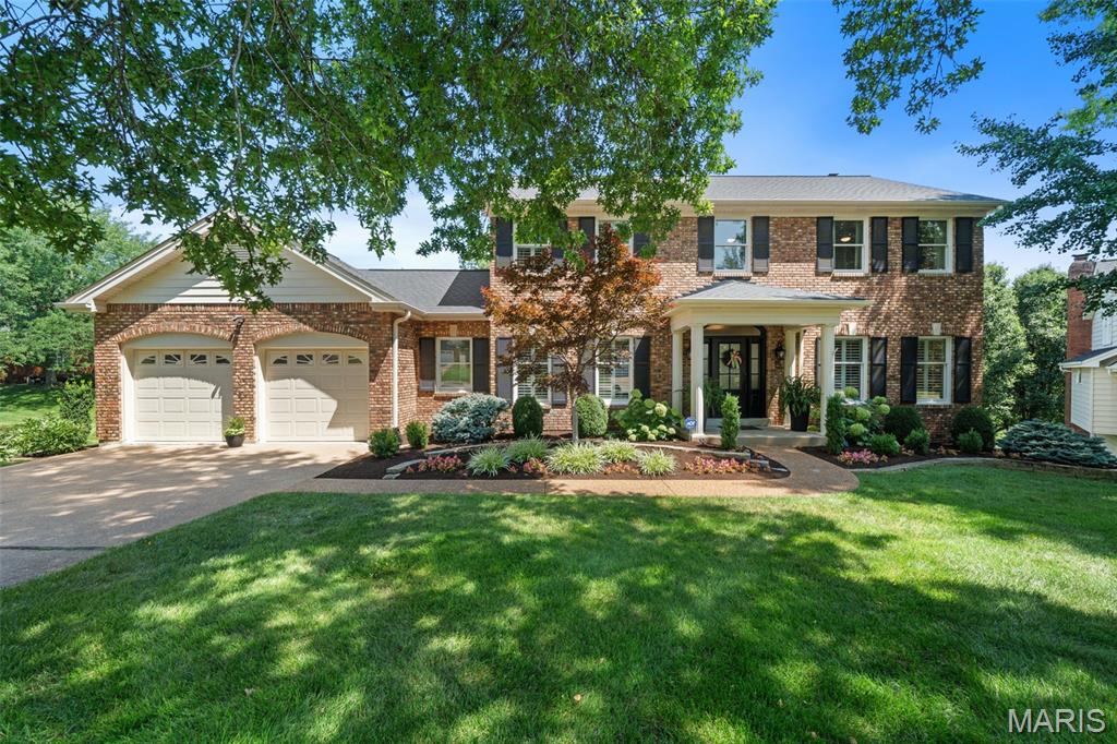 Set on a quiet cul-de-sac in the heart of Des Peres and within the sought-after Parkway South School District, this exceptional 5-bedroom, 5-bath residence offers a level of space, craftsmanship, and thoughtful updating that is increasingly difficult to find. A welcoming foyer opens to beautifully maintained living spaces highlighted by rich hardwood floors, extensive crown molding, custom built-ins, and abundant natural light from new Andersen front windows. The updated kitchen serves as the centerpiece of the home, featuring quartz countertops, a large center island, built-in ice maker, premium appliances, and seamless connection to the breakfast room where a stone fireplace creates the perfect setting for slow mornings and everyday gatherings. Designed for both entertaining and comfortable daily living, the main level flows effortlessly between formal and casual spaces, while two stone fireplaces add warmth and character throughout the home. Upstairs, the spacious primary suite offers a true retreat with custom walk-in closet and a beautifully updated bath featuring dual vanities, a freestanding soaking tub, and separate shower. Generously sized secondary bedrooms provide flexibility for family, guests, or home office needs. The walk-out lower level is a showstopper. With impressive 9.5-foot ceilings, extensive finished living space, a full bath, and bedroom, plus an additional room for fitness, media, or game areas, it feels more like an extension of the main floor than a traditional basement. Outside, the composite deck overlooks the private backyard and creates an ideal space for outdoor dining, relaxing, or entertaining. An epoxy-coated garage floor, mature landscaping, and meticulous upkeep reflect the pride of ownership evident throughout the property. Combining timeless architecture, extensive updates, and an unbeatable Des Peres location, this is a home that offers it all!