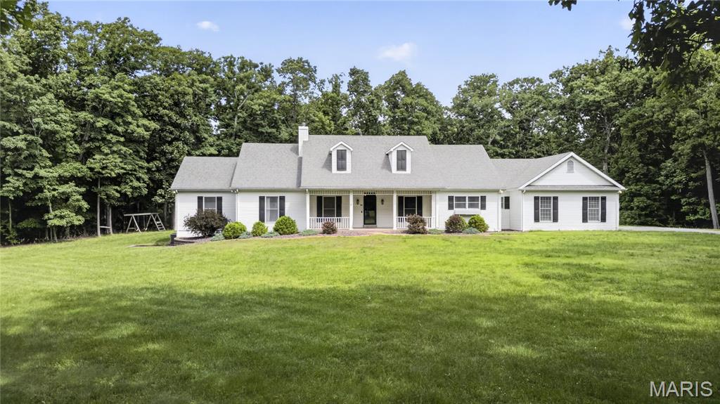This handsome and spacious 4 bedroom 4 bath ranch home is beautifully situated on a 3 acre lot surrounded by mature trees creating a private, peaceful oasis for relaxing and entertaining.  The recently refinished wide-plank hardwood floors are simply outstanding.  A large living/family room with fireplace leads to an outdoor brick terrace overlooking the salt water pool with waterfall.   The custom designed kitchen adjoins a family dining area with fireplace which opens to a screened-in porch.  The primary bedroom includes ample closet space and an en-suite bathroom with vaulted ceiling, separate shower, whirlpool tub, and a double vanity.  A finished lower level with wet-bar includes plenty of built-in bookcases and ample storage.  The oversized three-car garage offers additional storage space.  This remarkable  home is located in the coveted Francis- Howell School District.