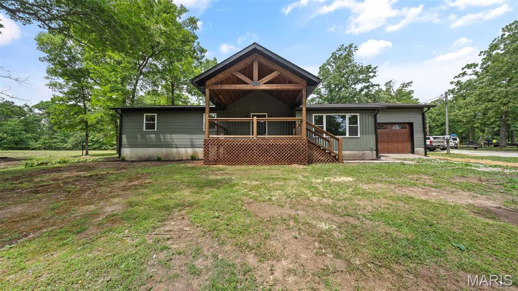 Beautifully remodeled 3-bedroom, 2-bathroom home on +/- 39.40 acres, ideally located just minutes from Rolla, Salem, and Licking! An inviting timber frame front porch welcomes you into the spacious semi-open concept interior featuring new finishes throughout. The living room features an electric fireplace on the shiplap wall and a picture window to take in the gorgeous views. The kitchen boasts custom cabinetry, a center island with seating, top-of-the-line appliances, and granite countertops. The mud/laundry room is conveniently located off the kitchen with access to the back porch and the attached one-car garage. The primary retreat hosts a private ensuite bathroom with a double vanity, extra storage, and a large walk in closet. This home sits on an unfinished walk-out basement offering endless possibilities for storage, recreation, or future expansion. The private wooded setting provides peace, seclusion, and abundant wildlife right outside your door. Whether you're looking for a full-time residence, hunting retreat, or private getaway, this property is a must-see! Home is also being listed with less acreage - see MLS 26038656.
