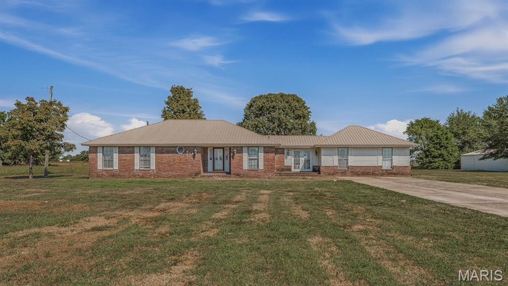 Stop Scrolling-This one has space, land, and country charm!  Looking for room to spread out without giving up convenience?  THIS IS IT!    518 State Highway M in Steele, Missouri has 4-bedrooms, 2-bathrooms, 2 acres, detached garage, fenced backyard, spacious closets and laundry room, extra room that is currently being used a playroom and hobby room, lovely breezeway with brick pavers, metal roof, and new floors installed in 2023.  If you've been waiting for a home with space, storage, land and country living, you need to see this one!
