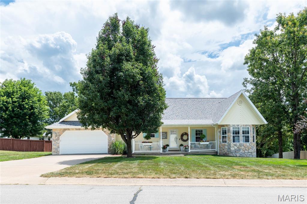 Meticulously maintained and thoughtfully updated, this exceptional 3400+ square ft home (1710 on the main level and approx. 650 finished in the basement, with additional unfinished space) in the Summit Pass Subdivision offers the perfect blend of quality craftsmanship, modern upgrades, and functional living spaces—all just minutes from downtown Waynesville, Fort Leonard Wood, shopping, dining, and local amenities.

Step inside to discover upgraded flooring throughout most of the home, including premium vinyl plank flooring, thoughtfully selected tile, and plush premium carpet in the spacious primary suite. Updated lighting throughout creates a bright, inviting atmosphere, while the custom fireplace surround with built-in TV cabinetry serves as a stunning focal point in the living room.

The beautifully appointed kitchen is designed to impress with custom cabinetry, granite countertops, stainless steel appliances, a KitchenAid stove and dishwasher, and abundant storage for all your culinary needs.

The private primary suite offers a relaxing retreat featuring a luxurious tiled, no-step walk-in shower and a jetted soaking tub. Throughout the home, you’ll appreciate the exceptional storage options and meticulous care that has gone into every detail.

Downstairs, the walk-out basement provides an expansive second living area equipped with a built-in wet bar & beverage cooler, a 3/4 bathroom, along with multiple unfinished storage spaces- one of which has the potential to be finished as a fourth bedroom. A storm shelter adds additional peace of mind.

Enjoy outdoor living on the covered back deck complete with ceiling fans, overlooking a fully fenced backyard enclosed with a beautiful cedar privacy fence. The lawn has been professionally maintained with annual fertilizer and bug prevention treatments, reflecting the pride of ownership found throughout the property.

Additional highlights include a new roof, a new HVAC system installed in 2020 with documented annual maintenance, a security system available for added convenience, and countless updates that make this home truly move-in ready.

If you’ve been searching for a home that combines comfort, quality, and an unbeatable location, this one is ready to exceed your expectations.