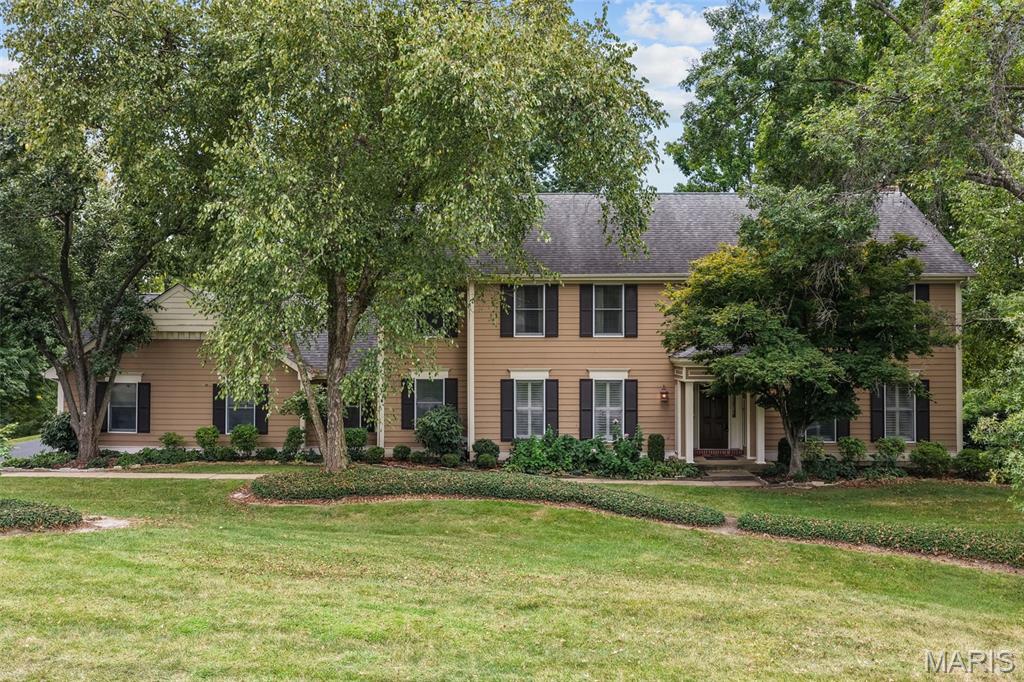 Your dream of a luxurious Town & Country home has just come true! Situated on a park-like .6 acre lot in a quiet cul-de-sac, this home has over 5,000 square feet of well-maintained and beautifully updated space. You’ll have wonderful curb appeal with a side-entry three-car garage, a covered front porch, and large trees shading the meticulous landscaping. The two-story foyer opens to the formal living room to the right and dining room to the left. No detail has been overlooked: gleaming hardwoods, dentil crown molding, millwork, plantation shutters, stylish lighting, and built-in bookcases. The gorgeous wood-paneled family room with a cozy gas fireplace flows seamlessly into the showstopper kitchen, creating an inviting space to host gatherings or just relax with family. You’ll love the caesarstone-topped wet bar with a wine rack and beverage coolers that connects the kitchen to the family room. The spacious breakfast room leads to the gourmet kitchen, boasting custom cabinets with lighting, an island with a breakfast bar, top-of-the-line stainless steel appliances, stone tile backsplash, and ceramic tile floors. A half bath with pedestal sink and convenient laundry room completes the main level. Upstairs, the primary suite is a retreat with built-in bookcases, dual walk-in closets with organizers, and a spa-like bathroom with dual-sink vanity, jet tub, and step-in shower. Three more bedrooms feature hardwood floors, and the other two upstairs baths have been renovated with brushed-gold fixtures, charming vanities, and tile-surround tubs. The walk-out finished lower level adds an expansive rec room with a wet bar, brick-surround gas fireplace, built-ins for storage, as well as a 5th bedroom, and an updated bathroom with step-in shower. Enjoy the fall weather on the covered patio or the deck that spans the back of the home and overlooks the backyard and woods beyond. Located in a wonderful neighborhood community, with quick access to schools, highways, golf, shopping,restaurants, hospitals, and medical centers. This home has everything on your list and more!