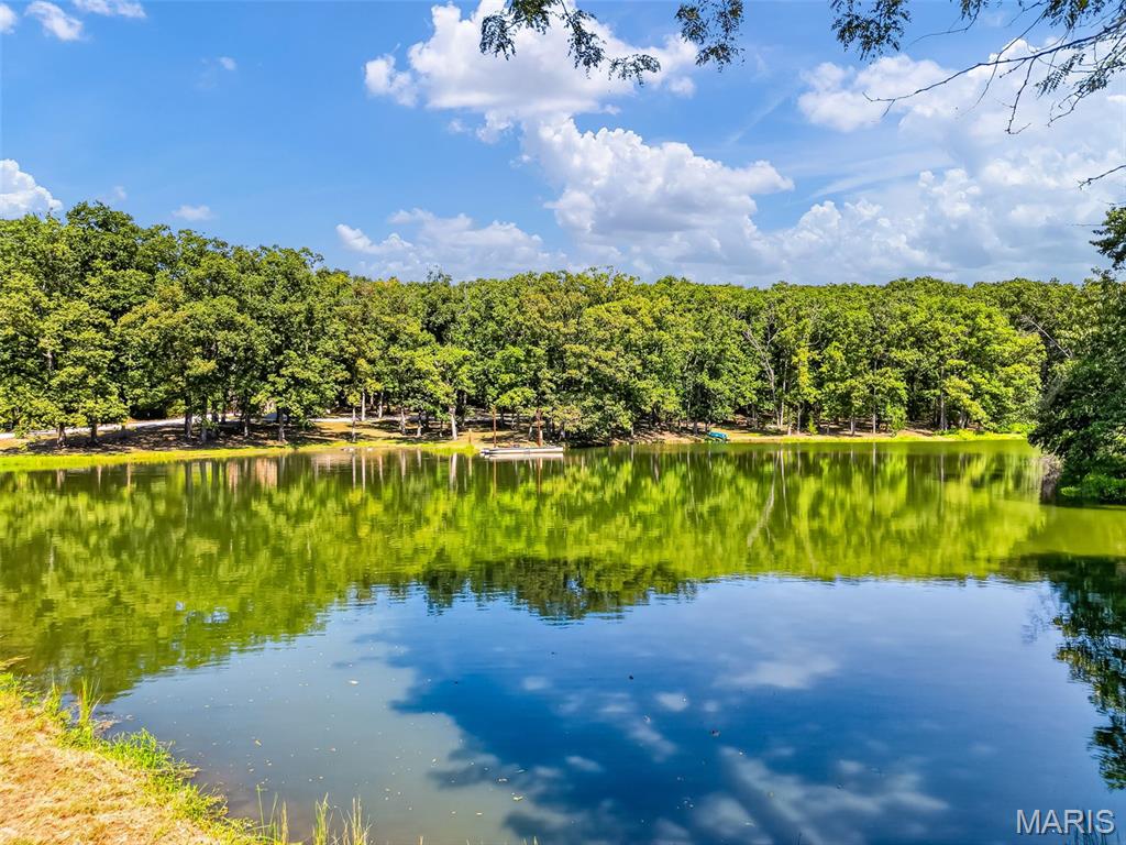 Escape to your own private retreat at 26193 Deer Lake Dr in Warrenton! This beautiful 10.03-acre parcel in Deer Lake Estates offers a perfect blend of recreation, relaxation, and outdoor adventure. The property features a stocked pond with a pontoon dock, providing a great spot for fishing and enjoying the peaceful surroundings. A shed with electric includes a small efficiency-style living area with a bathroom and shower, 23'x9' kitchenette, water heater, and air conditioner, making it a convenient place to enjoy weekends or time outdoors. Mowed trails wind through the wooded acreage and are ready for ATV riding and exploring. Whether you’re looking for a private hunting and recreational property, a weekend getaway, or a place to enjoy the outdoors, this property offers plenty of possibilities. Come experience the privacy and natural beauty this 10.03-acre retreat has to offer!