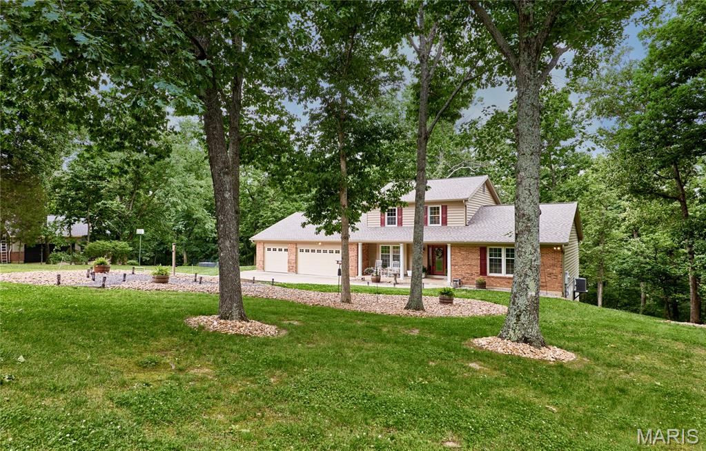 Tucked away on 3 wooded acres, this meticulously maintained 4-bedroom, 2.5-bath home offers over 2,600 sq ft of comfortable living space, combining privacy, functionality, and stylish updates.
The main floor is filled with natural light and features a spacious primary suite with walk-in closets, convenient main-floor laundry, a separate dining room, and a flexible front living room/office. The updated kitchen showcases solid amish cherry cabinetry, Cambria quartz countertops, stainless steel appliances, and opens seamlessly to the breakfast area and family room, complete with a wood-burning fireplace. Step outside to the low-maintenance deck (new in 2021) overlooking the backyard, creating the perfect space for relaxing or entertaining.
The walkout lower level offers exceptional storage space and includes a bathroom rough-in, providing excellent potential for future finishing. Outside, enjoy the spacious yard, endless wildlife and extensively updated rock landscaping designed for both beauty and low maintenance. The oversized 3-car garage provides ample space for vehicles, storage, and hobbies. 
Recent major improvements include a new roof (2025), new dishwasher (2025), new window wraps (2026), new gutters (2026), fascia (2026), and garage doors with updated hardware (2026). This move-in ready home offers space, updates, and flexibility both inside and out. Close to major highways and all that Defiance, Augusta, Chesterfield and Saint Charles has to offer!
Sellers are offering up to $2,500 credit towards closing costs.