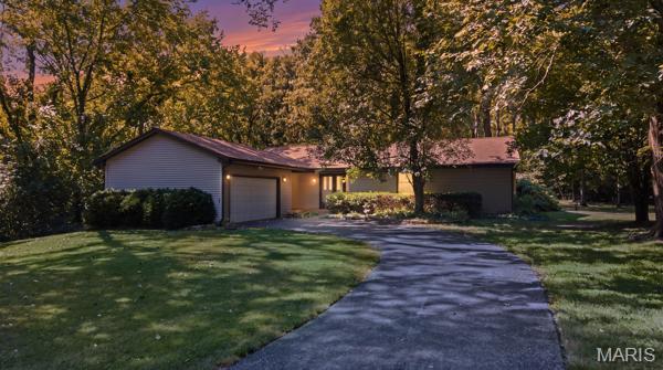 5.08 PARK-LIKE WOODED ACRES + NEARLY 3,000 SQ. FT. OUTBUILDING! A RARE FIND IN ST. LOUIS COUNTY!

If you've been searching for space, privacy and possibilities, 801 Coal Bank Rd. deserves your attention. This distinctive 3-bedroom, 2.5-bath ranch offers approximately 1,680 sq. ft. on the main level plus a finished walkout lower level, all nestled on 5.08 park-like wooded acres.

Inside, soaring 14-foot vaulted wood ceilings, exposed beams and a dramatic stone fireplace with a wood-burning insert bring warmth and character to the main living space. Large windows showcase peaceful views of the property, where deer, wild turkey and fox are frequent visitors. The kitchen features granite countertops and abundant cabinetry, while a second bedroom with a bay window and built-in desk creates an ideal work-from-home space surrounded by nature. Additional highlights include a 2-car attached garage, new roof, attic fan, ceiling fans and an enclosed porch (offered as-is). 

The true standout is the impressive 62' x 48' outbuilding offering approximately 2,976 sq. ft. of workshop and storage space. Equipped with electric, concrete flooring, extensive lighting and multiple oversized access doors (approx. 10'x12', 9'x7', 8'x7' and 15'x7'), it offers exceptional versatility for the car enthusiast, hobbyist or collector, with plenty of room for equipment, boats, recreational vehicles and more. 

With acreage, wildlife, a finished walkout lower level and an extraordinary outbuilding, this one-of-a-kind property offers the kind of space and flexibility that's increasingly hard to find in St. Louis County.
