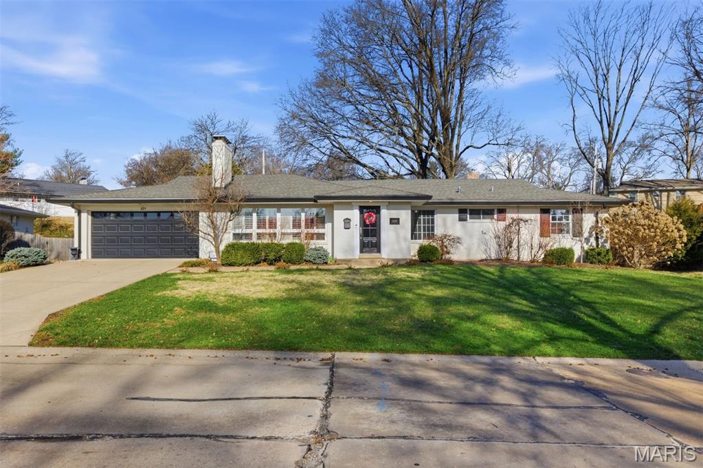 Space, light, and effortless ranch living—set on a rare .4-acre lot in sought-after Warson Woods.
This beautifully refreshed 4-bedroom, 3-bath residence offers an exceptional blend of timeless design and modern comfort. Expansive windows and warm hardwood floors create a bright, airy atmosphere throughout the main living spaces, where the gracious living room centers around a classic fireplace framed by custom built-ins, offering both charm and function.
The adjoining dining area flows effortlessly for entertaining, while the bright white kitchen features generous cabinetry, stone countertops, stainless appliances, and a sunny breakfast space overlooking the backyard.
The primary suite is a peaceful retreat with abundant natural light and generous proportions, while two additional bedrooms and well-appointed baths provide flexible living for guests, family, or work-from-home needs.
The finished lower level adds impressive additional living space, offering a large recreation area ideal for movie nights, gatherings, or play, along with a full bath and ample storage.
Outdoors, the property truly shines. The expansive .4-acre lot creates a rare sense of privacy and openness, with a spacious patio perfect for dining and entertaining. A tranquil water feature adds a soothing focal point, creating a backyard setting designed for relaxation and connection.
With its airy interiors, beautifully scaled living spaces, and coveted Warson Woods location, this home offers an exceptional opportunity.