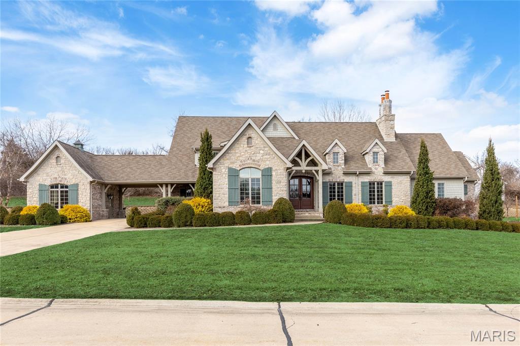 An impressive brick, stone & cedar elevation highlights the remarkable curb appeal of this spectacular 1.5 Sty. Located in a gated enclave of custom-built homes. Vaulted porch entrance with timber trusses & extraordinary 8’ arched mahogany double doors leads to foyer lined by wide plank hardwoods that extend into the private study and stunning great room with beamed cathedral ceiling, floor-to-ceiling stone fireplace flanked by bookcases & atrium doors that open to outdoor living area. Custom designed kitchen featuring quartz countertops, Shaker cabinetry, premium stainless steel appliances, 6’ center island & convenient kitchen office adjoins breakfast room with built-in wall unit. Coffered primary bedroom suite with customized walk-in closet & luxury bath with shower spa & freestanding tub offers an appealing retreat. The 2nd floor extends the living quarters with 3 additional bedrooms, 1 with ensuite bath, & Jack n’ Jill bath. Lower Level entertainment space includes recreation room & game room plus workout room & half bath. Situated on an extensively landscaped .76-acre cul-de-sac lot with covered & open patios, oversized 1 & 2-car garages & porte cochere.