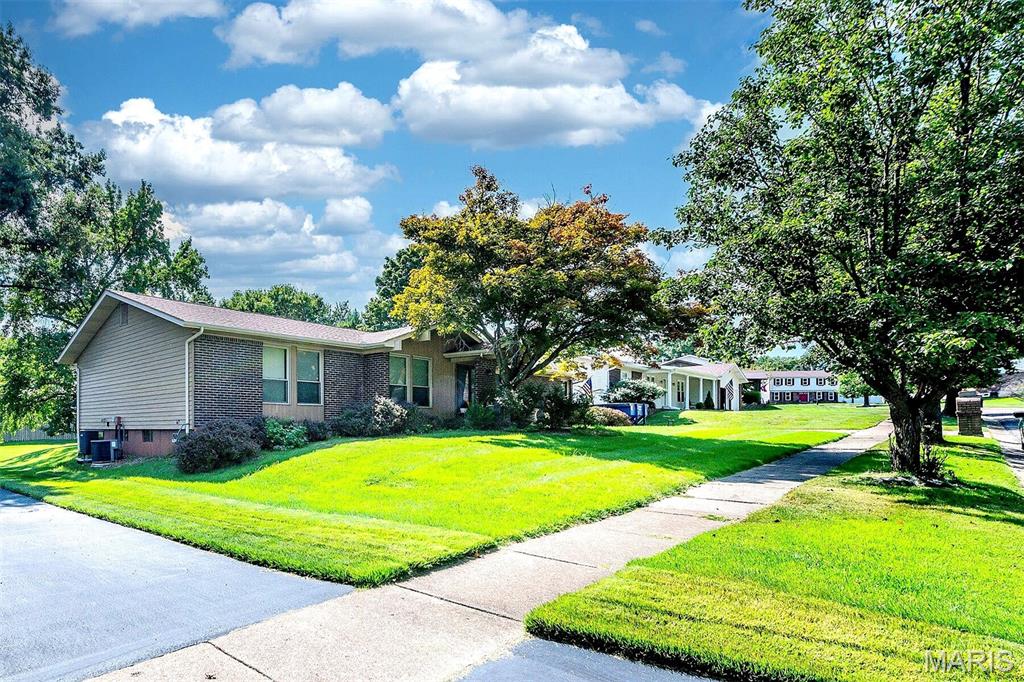 Welcome to 12834 Branchmont Court, a spacious ranch tucked away on a quiet cul-de-sac in the desirable Seven Pines community. From the moment you arrive, the brick exterior, low-maintenance siding, and beautiful stamped-concrete driveway and walkway create an inviting first impression. Inside, the generous living room flows naturally into the family room, where a cozy fireplace and atrium doors create a warm gathering space with easy access to the expansive patio and backyard. The bright kitchen offers abundant cabinetry, a center island, and an adjoining breakfast room, providing a functional layout for everyday living and entertaining. Three comfortable bedrooms include a primary suite with a spacious organized closet and private bath with dual sinks. The finished lower level expands the living space even further with a large recreation area and additional bath, making it ideal for entertaining, a home office, fitness space, hobbies, or guests. Car enthusiasts and hobbyists will appreciate the finished garage with rear-entry access and additional amenities, while the stamped-concrete patio provides a wonderful setting for outdoor dining, relaxing, and entertaining. Residents of Seven Pines can enjoy neighborhood amenities including a subdivision pool and park, while nearby Creve Coeur Park and Lake offer miles of walking and biking trails and plenty of opportunities to enjoy the outdoors. Convenient access to shopping, dining, major roadways, and everyday necessities completes the package. With generous living spaces, flexible l