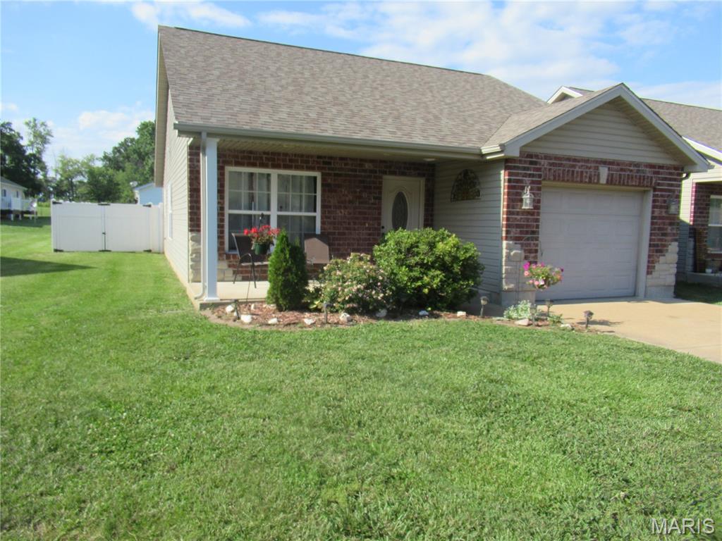 H2257  DESIRED NEIGHBORHOOD! This neighborhood has a community playground and sidewalks for strolling your babies. Lovely drive-by appeal with brick and stone front accent. Three bedrooms, 2 baths, 1 car garage. All electric home with forced air heat and central air. OPEN living/dining/kitchen area. Oak cabinets. Refrigerator, range and dishwasher included. Walk-in closet in master bedroom and shower in master bath. No carpeting. Laminate and ceramic tile floors. Most of home's walls have been recently painted. Vinyl privacy fenced back yard. Level back yard for all your family's outdoor activities. Landscaped front with covered 8x16 front porch. Located close to the Middle School and Kindergarten.