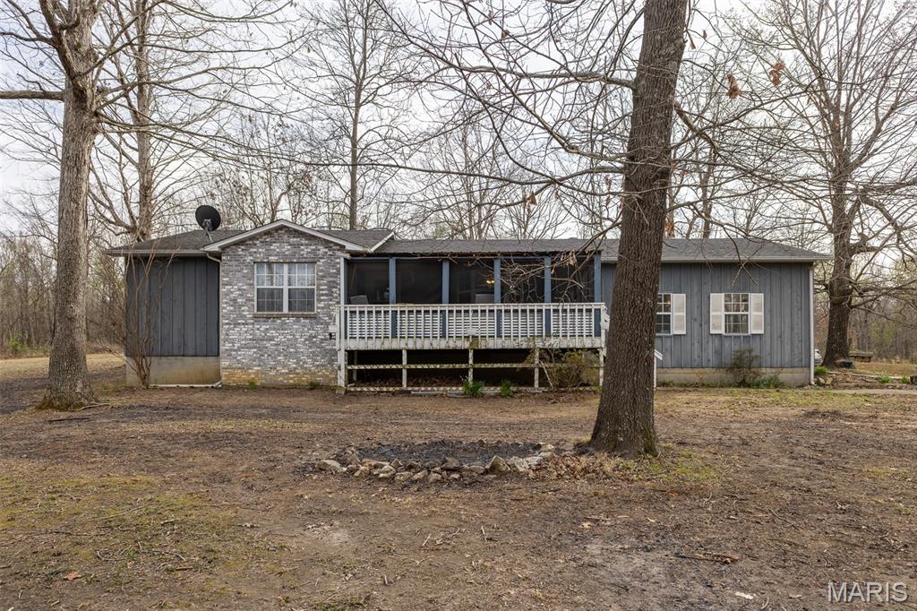 Enjoy peaceful country living with this charming 3-bedroom, 2-bath home on 13± acres at the end of a quiet dead-end road on Moreno Lane. Overlooking a stocked spring fed pond, it’s perfect for hobby farmers, mini-farm enthusiasts, or anyone craving open space and privacy. The home includes a 2-car garage with a 6x8 utility room and a cozy screened-in covered front porch for relaxing and taking in the views. Outside, you’ll find a pool, chain-link fenced backyard, 24x28 shop, and 8x10 outbuilding for extra storage. The property features garden areas, two fields ideal for livestock, and abundant deer and wildlife, all bordered by privately owned land for added seclusion. A great bonus is the tiny home with a metal carport, perfect for guests, in-laws, or rental income, along with multiple building sites for future plans. Located in the sought-after Neelyville School District, including Hillview Elementary, this property offers rural charm, functional acreage, and versatile amenities—without restrictions or HOA.