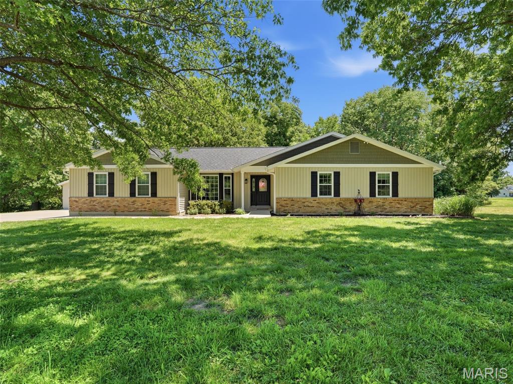 A rare opportunity tucked away on 3 beautiful acres. This 4 bd, 2.5 ba ranch offers the perfect blend of space, accessibility, serenity, comfort and outdoor living.  Experience this peaceful living all while keeping you just minutes from shopping, restaurants, and major highways.  Let the natural light and nature views meet you inside this gem of a home. Vaulted Great room with wood burning fireplace meets the kitchen of your dreams!  This spectacular, light filled kitchen offers loads of counter and cabinet space.  Want to host a party? - Roll out your long table and embrace making memories with your guests.  Just be careful, they will not want to leave.  Want to take the party outside?  HUGE deck overlooking this mesmerizing oasis hosting a 2 yr. new pool, pool deck and hot tub.  In this primary bedroom, you will wake up every morning thinking you are on vacation while gazing out the window admiring your peaceful retreat.  En Suite bathroom for privacy.  Two other bedrooms on the main floor as well as hall bath.  Walk out lower level offers loads of storage, 4th bedroom, bathroom and screened in porch.  Check out the SIX CAR GARAGE!!  4 car attached and 2 car detached that is currently being used as the cleanest wood working shop we have ever seen!  Detach garage has a mini split HVAC so you can use it all year long.  Whether you are hosting gatherings, diving into your hobbies or simply enjoying the serenity of nature, this property delivers the lifestyle you've been dreaming of.