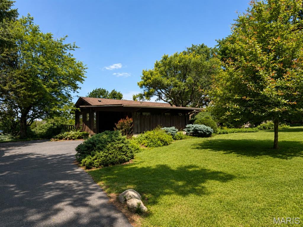 This wonderful home is located in a great area and features classic mid-century modern design with large windows and a spectacular lot offering beautiful views. The home includes 3 bedrooms, 2.5 baths, and a full walk-out lower level. While it could use some updating, it offers incredible potential and a rare opportunity to make it your own. Spend relaxing evenings overlooking the expansive backyard, surrounded by mature trees and peaceful scenery. A truly special property with timeless character and an exceptional setting.