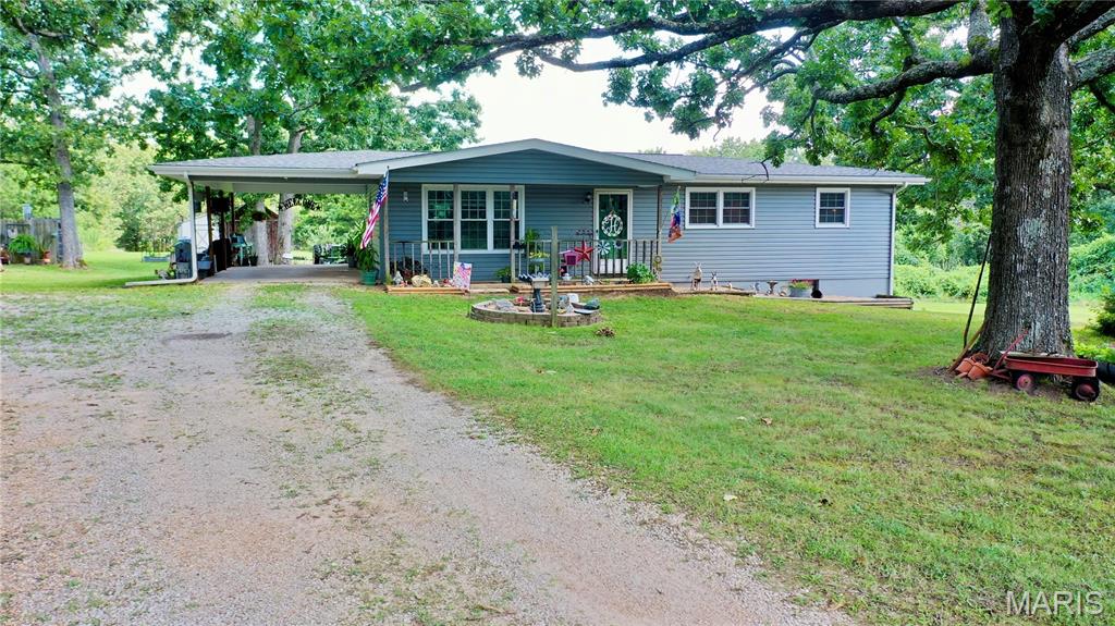 Premier Ozarks Hunting Retreat on 91 Acres! Discover the perfect blend of recreation, privacy, and country living just minutes from town on a chip-and-seal road. This exceptional property offers 91 acres of mostly wooded terrain with wildlife habitat, attracting abundant whitetail deer and eastern wild turkey, along with a scenic pond and open pasture. The well-maintained 3-bedroom, 1-bath home sits on a full walkout basement and features newer windows, siding, a roof less than 10 years old, and an HVAC system with a heat pump less than 5 years old. A Classic outdoor wood furnace provides efficient heat and endless hot water. The spacious kitchen includes an electric range, refrigerator, and separate dining area. A 40'x23' metal shop with concrete floors, electric, and a 40'x16' lean-to is ideal for equipment, ATVs, tractors, or hobbies, while two Morton outbuildings provide additional storage. Enjoy peaceful mornings overlooking the pond from the front porch, then spend the afternoon hunting your own land or exploring nearby Montauk State Park, the Current River, and thousands of acres of Mark Twain National Forest. Whether you're searching for a full-time home, hunting camp, or recreational getaway, this Ozarks property delivers the lifestyle you've been dreaming of.