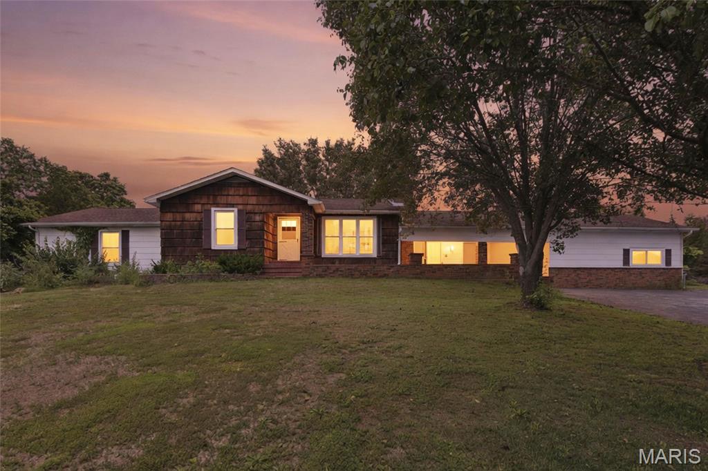 Welcome to this one-of-a-kind 3-bedroom, 2.5-bath home nestled on 1.6+/- acres, offering the perfect blend of rustic charm, spacious living, and convenience. From the moment you step inside, you’ll be captivated by the warm, natural character throughout—featuring stunning wood walls, wood ceilings, and custom-built wooden bookshelves that create an inviting and timeless atmosphere.
The thoughtfully designed interior boasts a generous layout with ample storage at every turn. A standout mudroom offers extensive built-in shelving and convenient access with double patio doors on each side—perfect for keeping everything organized while enjoying easy indoor-outdoor flow.
Relax and unwind in the enclosed sunroom, complete with a functional outdoor wood burning stove allowing you to enjoy the space year-round. Step outside onto the 14x10 covered deck overlooking the peaceful backyard—ideal for entertaining or simply enjoying the surrounding nature.
Those needing extra workspace will appreciate the attached garage with not one, but two workshop areas, along with a detached 32 x23' 3-car garage providing even more storage and flexibility.
The property features a paved driveway, mature trees that offer shade and privacy, a partially fenced backyard, and an additional shed for all your outdoor equipment.
Conveniently located just outside the city of De Soto, this home provides easy access to shopping, schools, and everyday amenities—while still offering the serenity of country living.
Property is being sold as-is.
Don’t miss your opportunity to own this unique and character-filled home!
