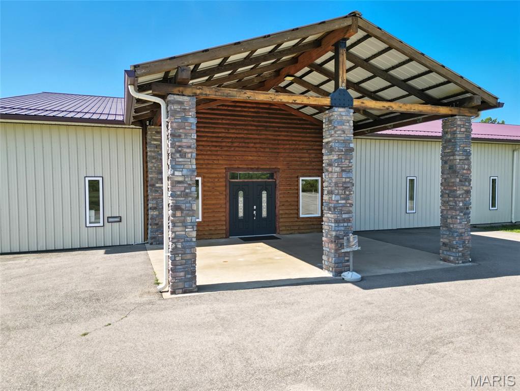 Seize this unique opportunity to own a versatile commercial property with nearly 1,000 feet of prime road frontage on Highway 67, just north of the Leadington exit, directly across from Mineral Area College. This high-traffic location offers exceptional visibility and accessibility, perfect for your next business venture! The main structure, a spacious 150 x 100-foot building, provides 15,000 square feet of flexible space currently housing Connection Church. With endless possibilities, this property could continue as a church or be transformed into a restaurant, banquet center, office building, or your dream project. The building features two main restroom facilities, an additional restroom with a shower, a large kitchen area, and multiple office or classroom spaces that can be reconfigured to suit your needs.
Additional income streams include a billboard generating $2,400 annually and a cell tower bringing in $7,200 per year. WE HAVE A QUALIFIED BUYER FOR THE CELL TOWER so you could buy the property and sell the cell tower at closing and use for your down payment! Call for details!  The property also includes two separate buildings with a total of 44 self-storage units which are currently vacant and could be rented to increase the cash flow by upwards of $3500/month. There is also an area with existing hookups for a modular home, adding to its versatility. With its strategic city location, high-traffic exposure, and highway frontage, this property is a rare find. Incredible investment opportunity! Possible creative financing opportunity for a qualified buyer!